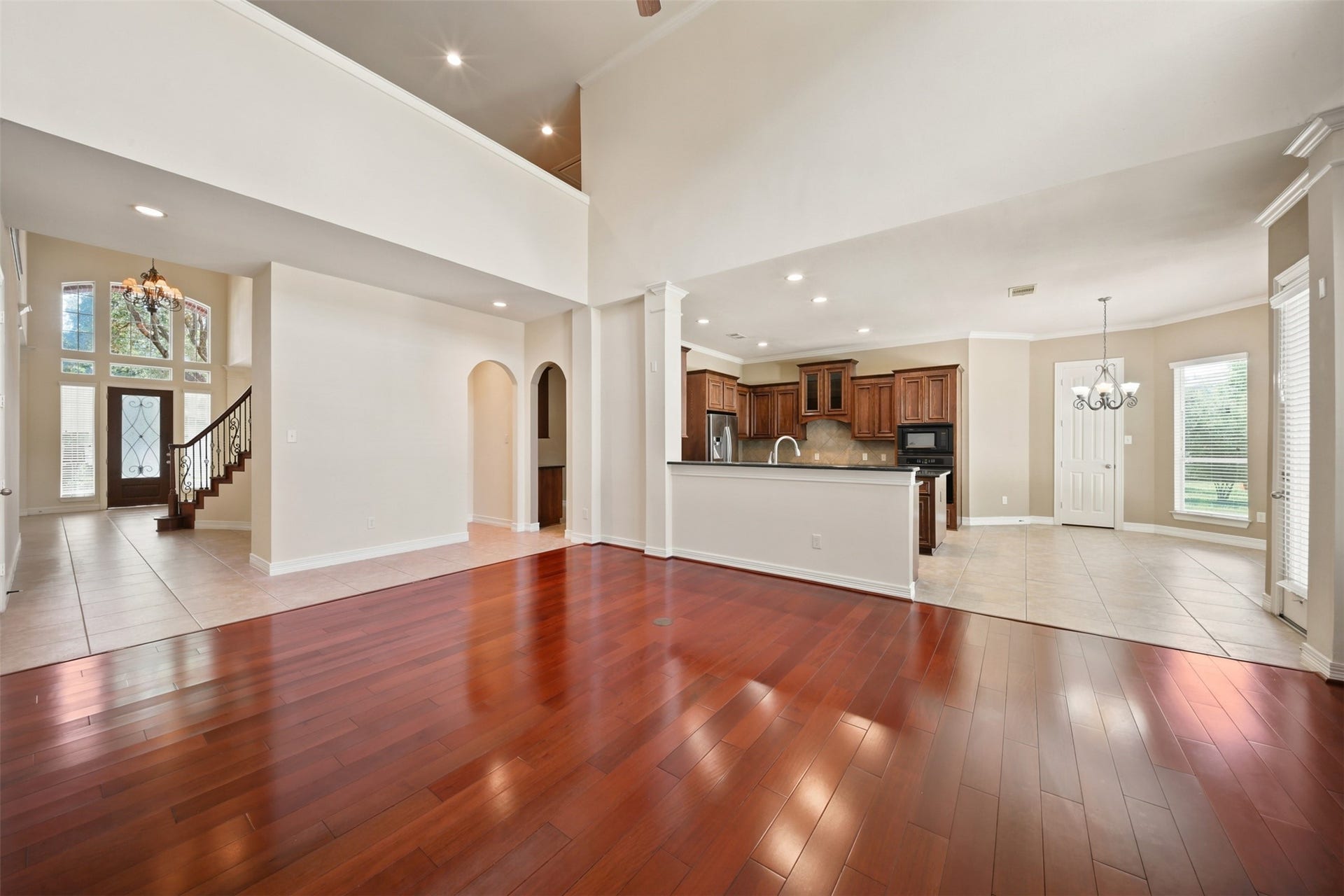 26306 Eden Point Court, Katy, TX 77494 Open family room view highlighting the hardwood flooring and connections to the kitchen, breakfast room, entry, and surrounding living areas.