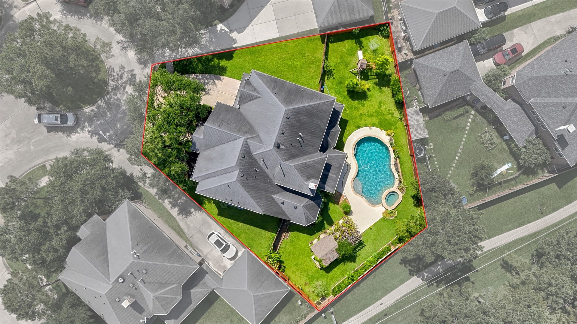 26306 Eden Point Court, Katy, TX 77494 Rear aerial view showcasing the brick exterior, pool and spa, covered outdoor areas, and generous fenced backyard.