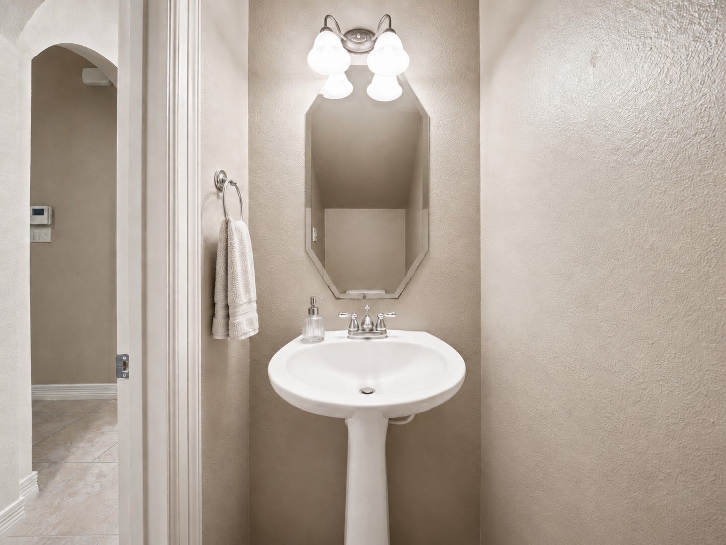 26306 Eden Point Court, Katy, TX 77494 Half bath with a pedestal sink, framed mirror, and vanity lighting.