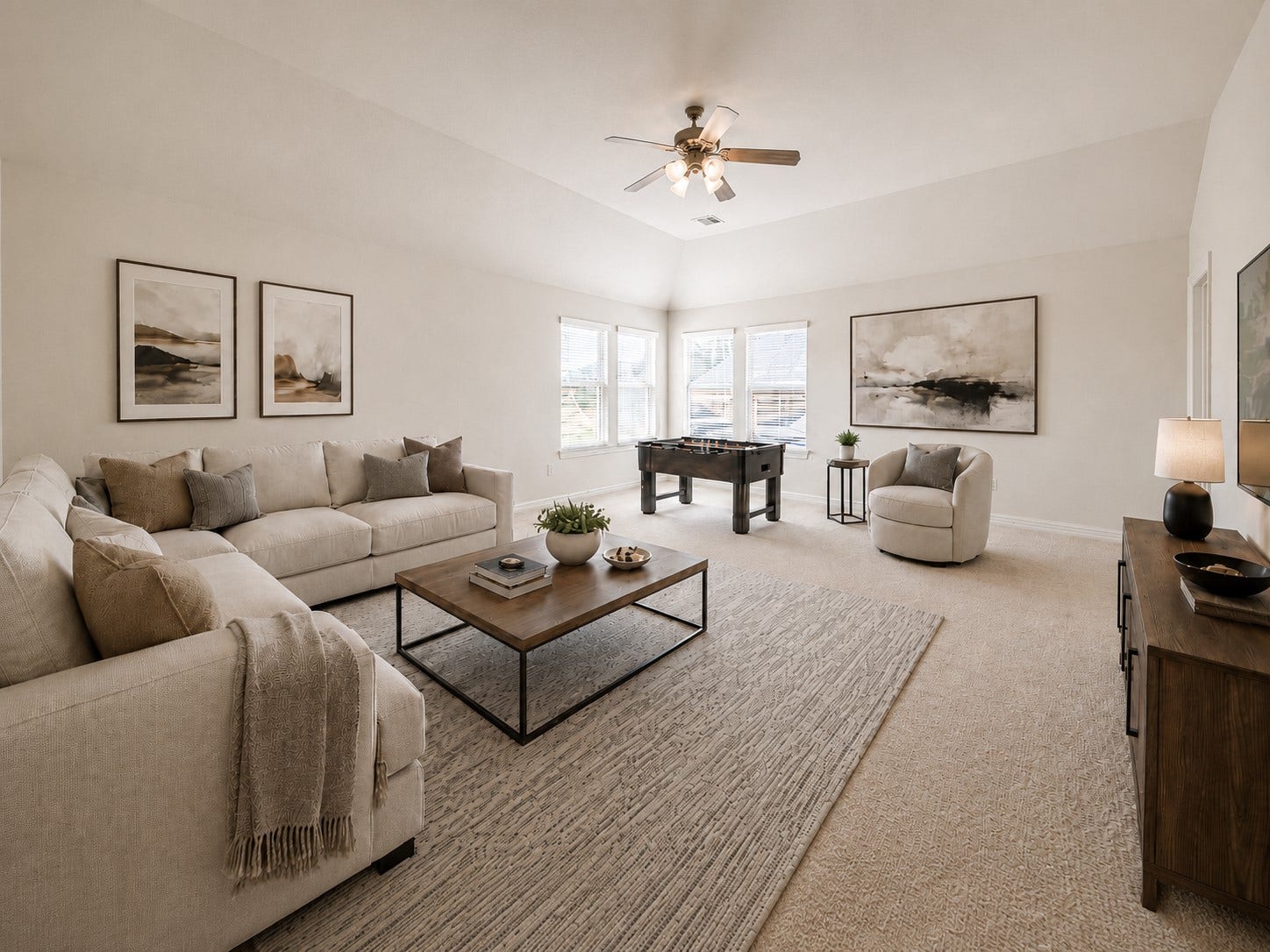 26306 Eden Point Court, Katy, TX 77494 Spacious game room with a vaulted ceiling, ceiling fan, multiple windows, and flexible space for recreation and media.