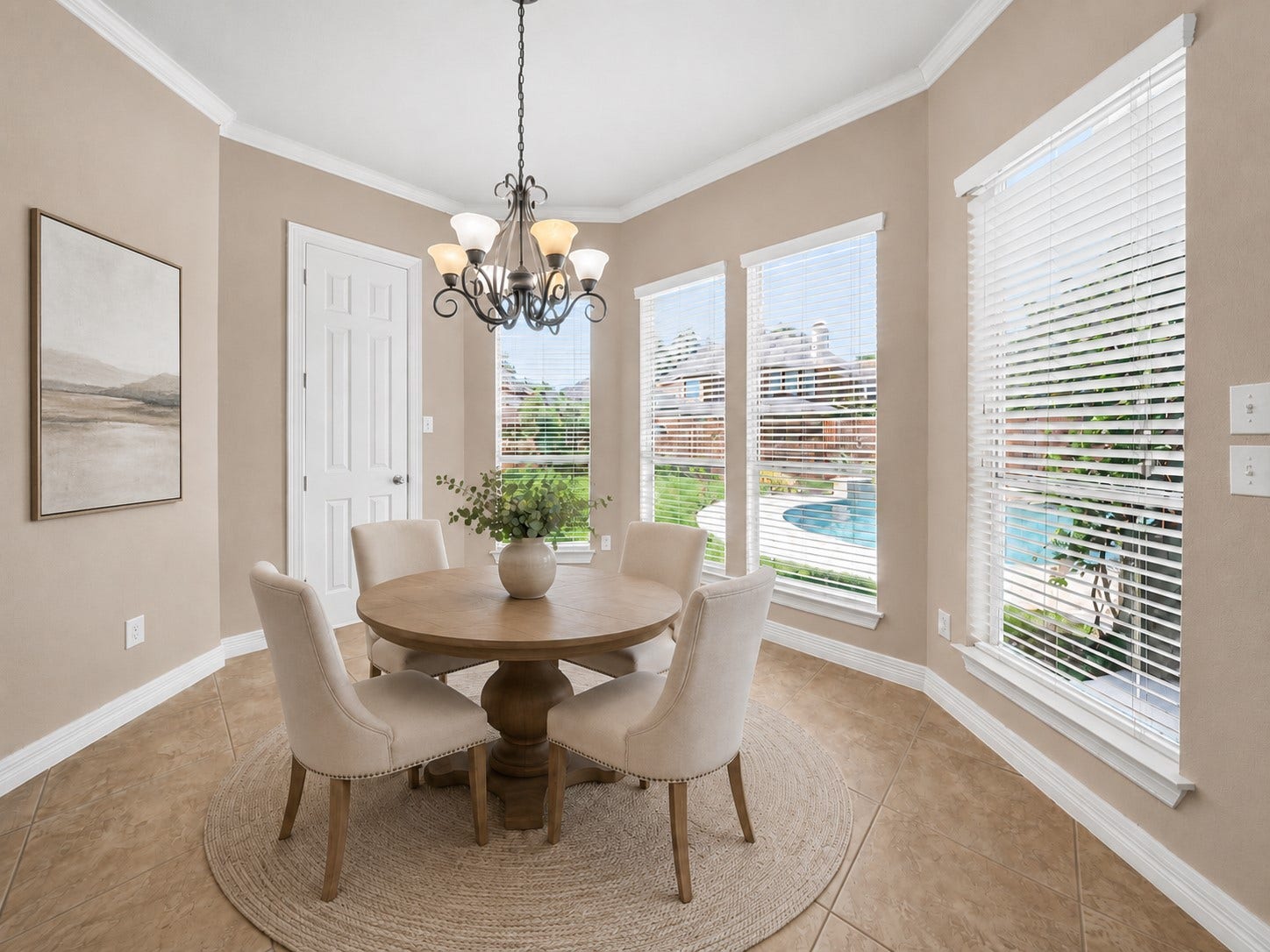26306 Eden Point Court, Katy, TX 77494 Breakfast room with crown molding, tiled flooring, a decorative light fixture, and multiple windows overlooking the backyard and pool.