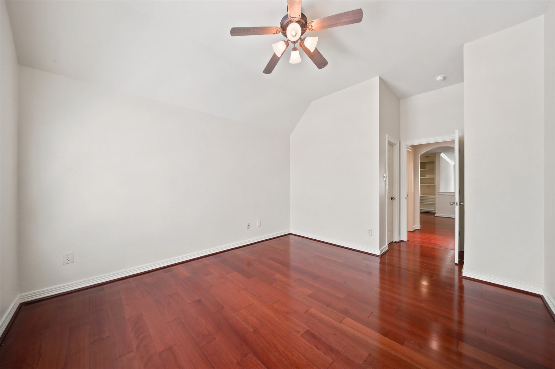 26306 Eden Point Court, Katy, TX 77494 Alternate bedroom view highlighting the spacious layout, vaulted ceiling, hardwood flooring, and adjacent hallway access.