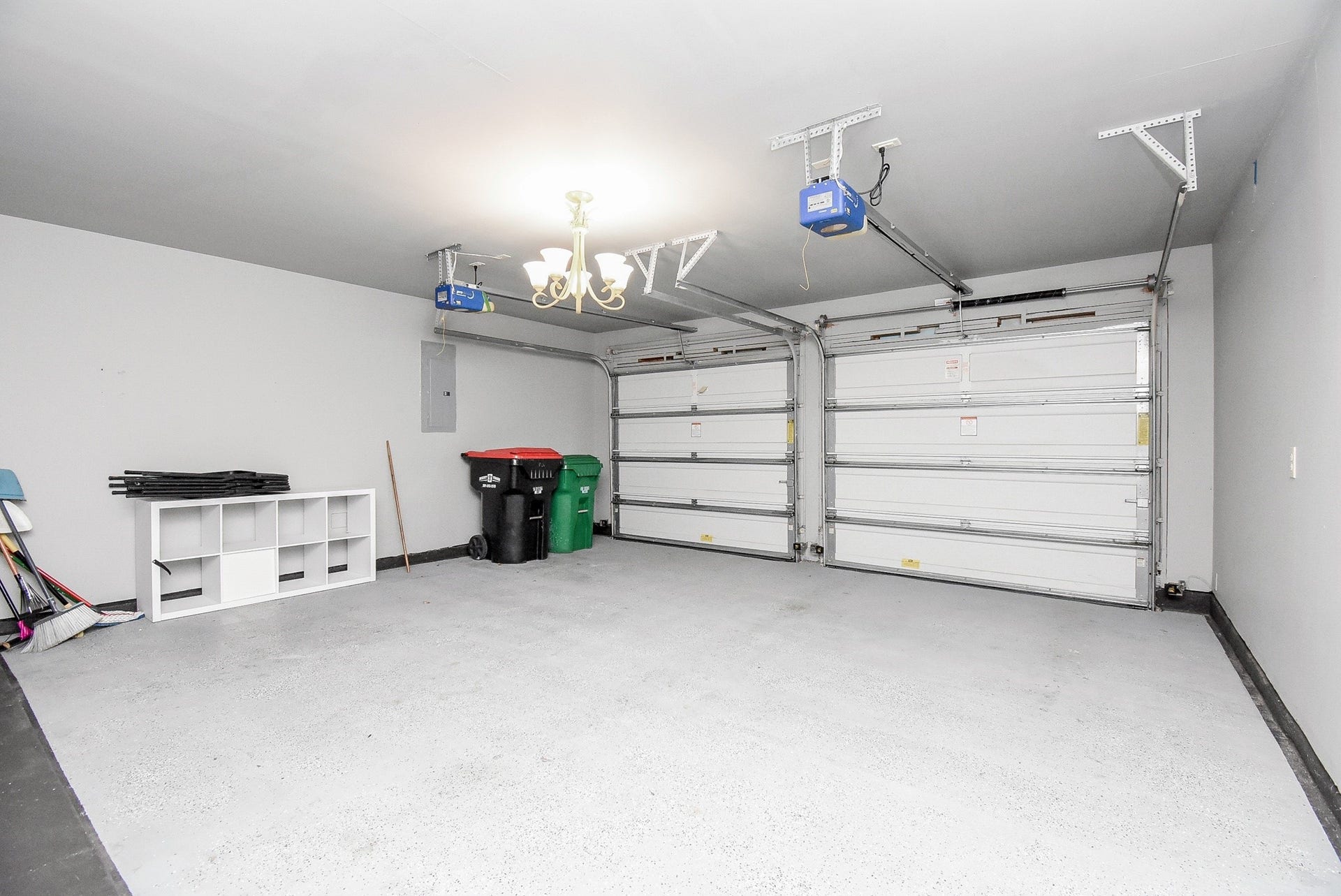 The two-car garage offers ample space for vehicles, storage, and hobbies. Featuring automatic garage door openers, durable epoxy-coated flooring, and plenty of room for shelving or a workshop, this clean and well-maintained space adds both functionality and convenience. Whether you're parking, organizing, or tackling weekend projects, this garage is designed to meet a variety of lifestyle needs.
