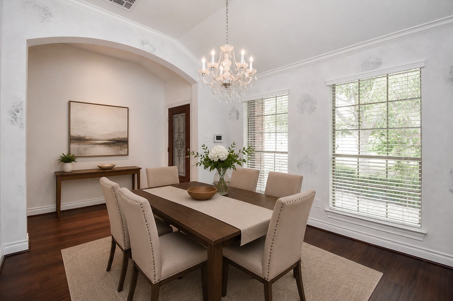 A gracious foyer welcomes you into a light-filled formal dining room featuring soaring ceilings, rich wood flooring, and the perfect setting for entertaining family and friends. Virtually staged.