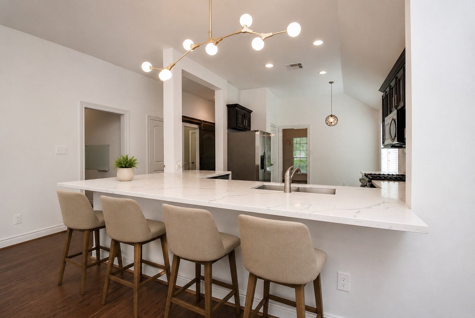 The oversized quartz island serves as the centerpiece of the kitchen, offering generous seating for casual dining, morning coffee, or gathering with family and friends. Combining style and functionality, this inviting space is perfect for entertaining and everyday living. Virtually Staged.
