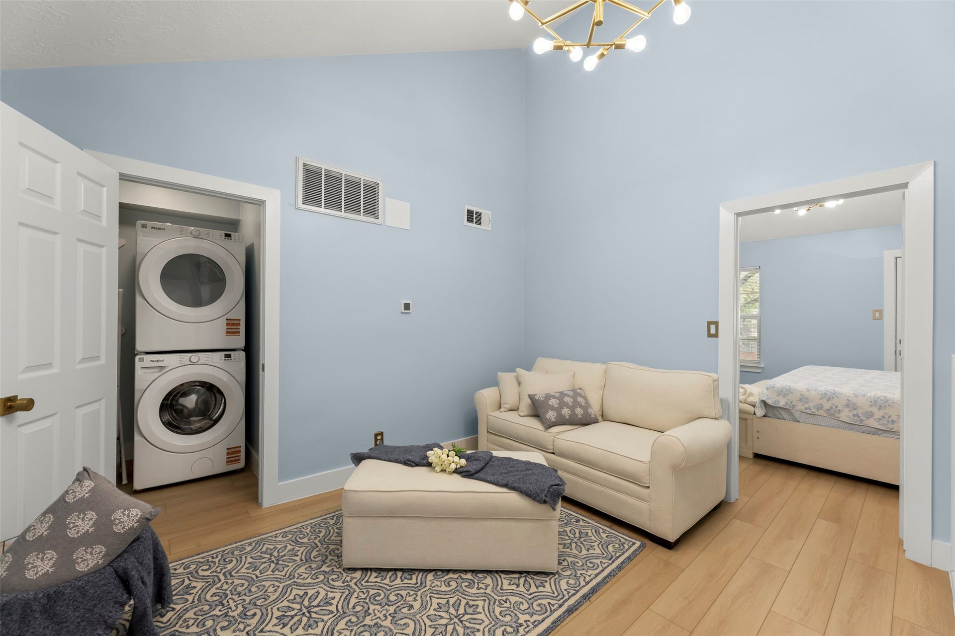 Experience versatility with a stylish flex area perfect for a home office or hosting guests, complete with a convenient laundry setup and a comfortable sofa-bed.
