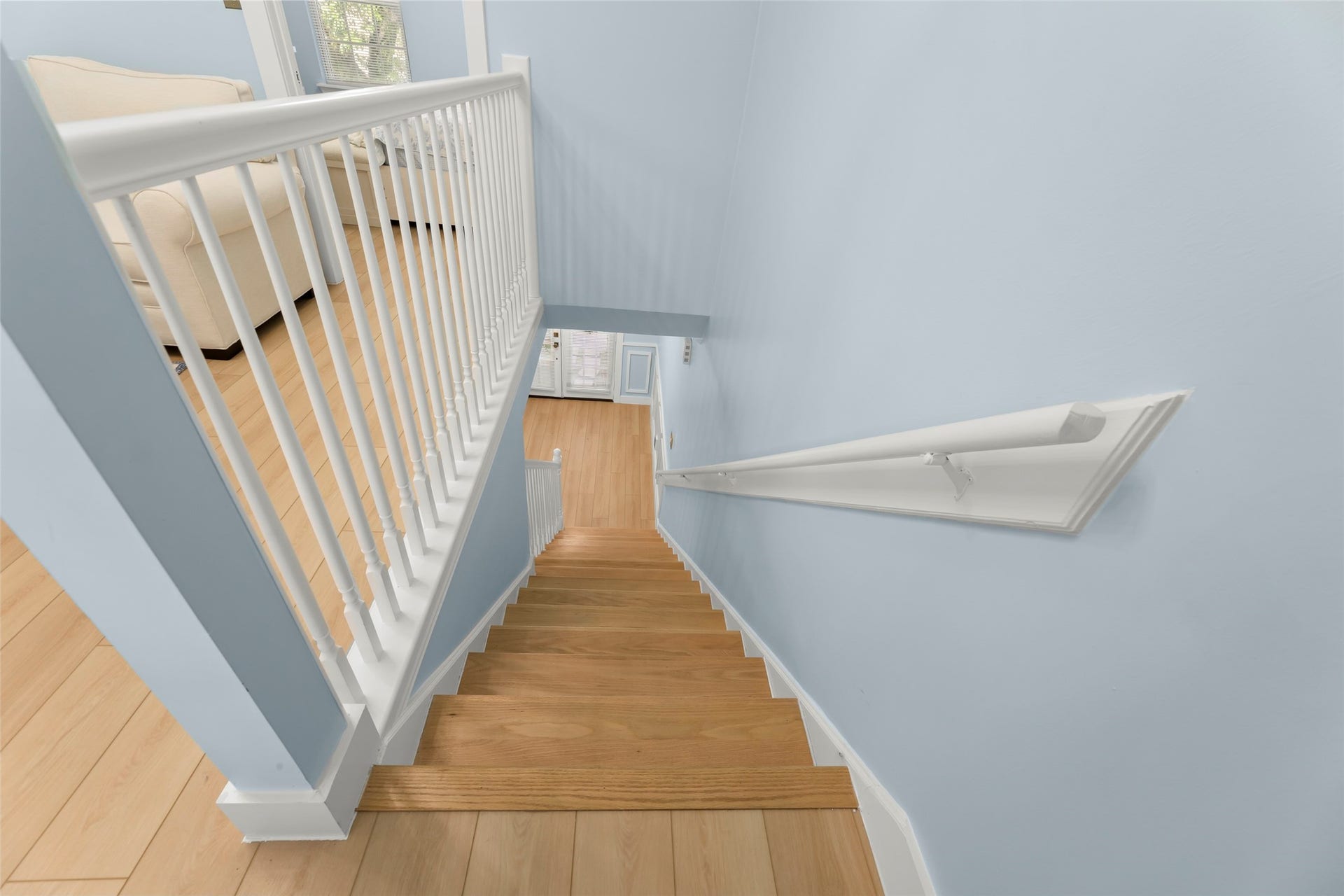 Experience modern living in this charming home featuring elegant wood stairs.