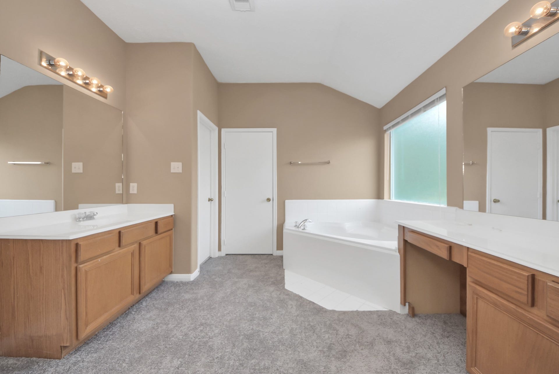 3006 Palace Oaks Drive, Houston, TX 77082 The primary bathroom offers dual sinks, a relaxing garden tub, a separate walk-in shower, and a convenient makeup vanity.
