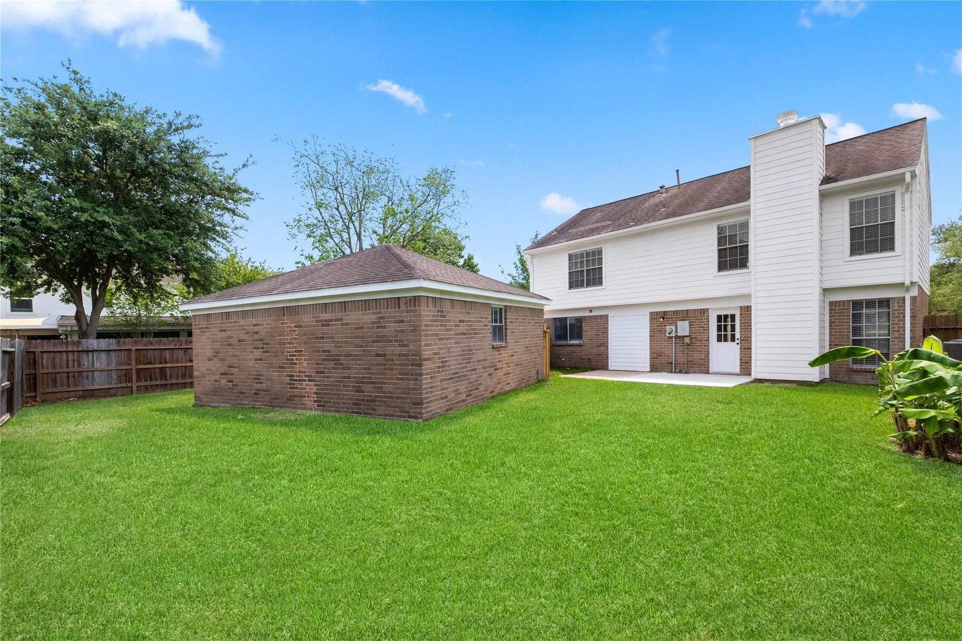 4523 Waterfall Way, Sugar Land, TX 77479 The fully fenced backyard offers plenty of green space for outdoor enjoyment and includes a detached two-car garage with additional room for storage.