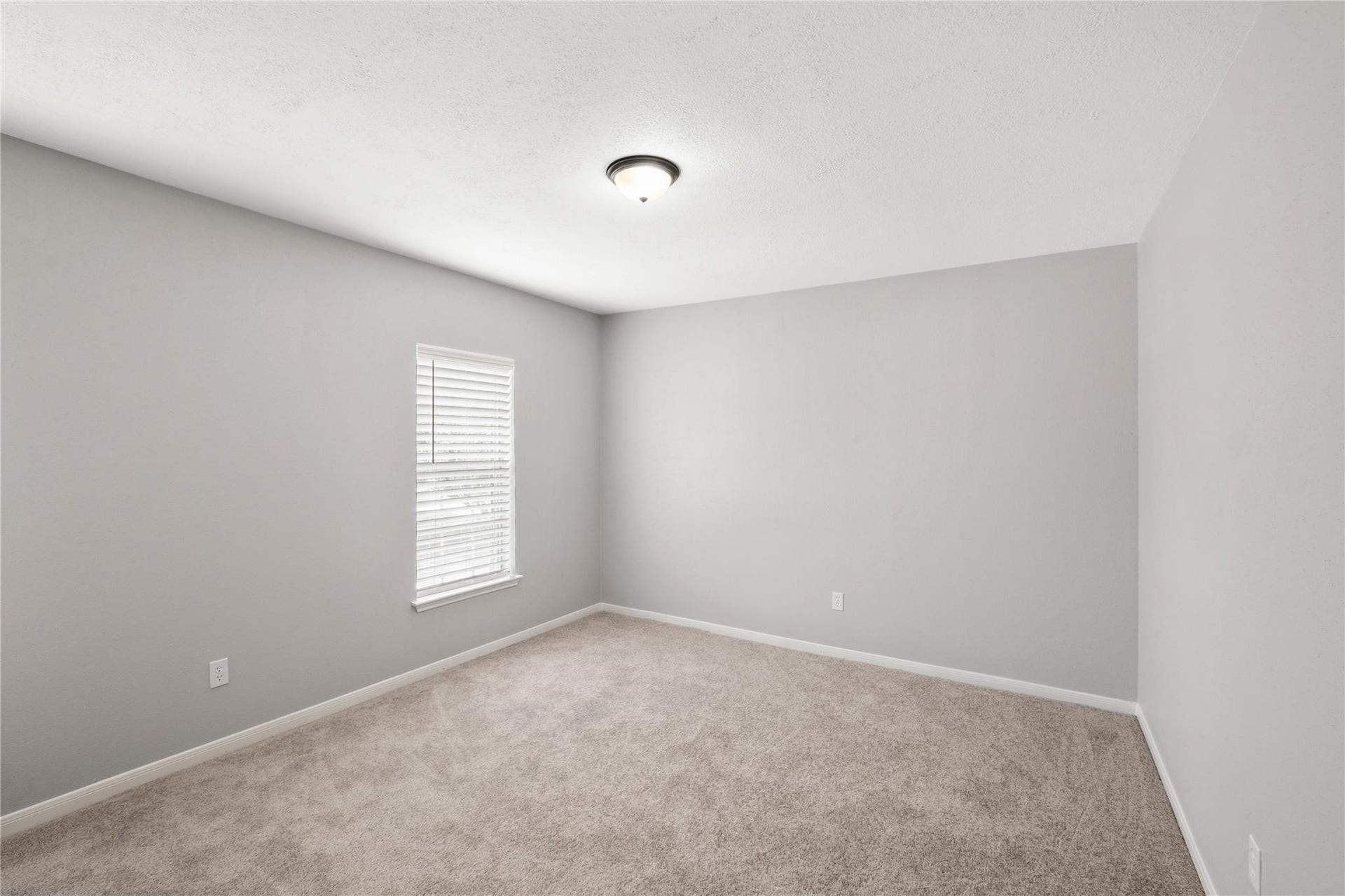 4523 Waterfall Way, Sugar Land, TX 77479 The upstairs second bedroom offers a comfortable retreat with soft carpeting, natural light, and plenty of space for family or guests.