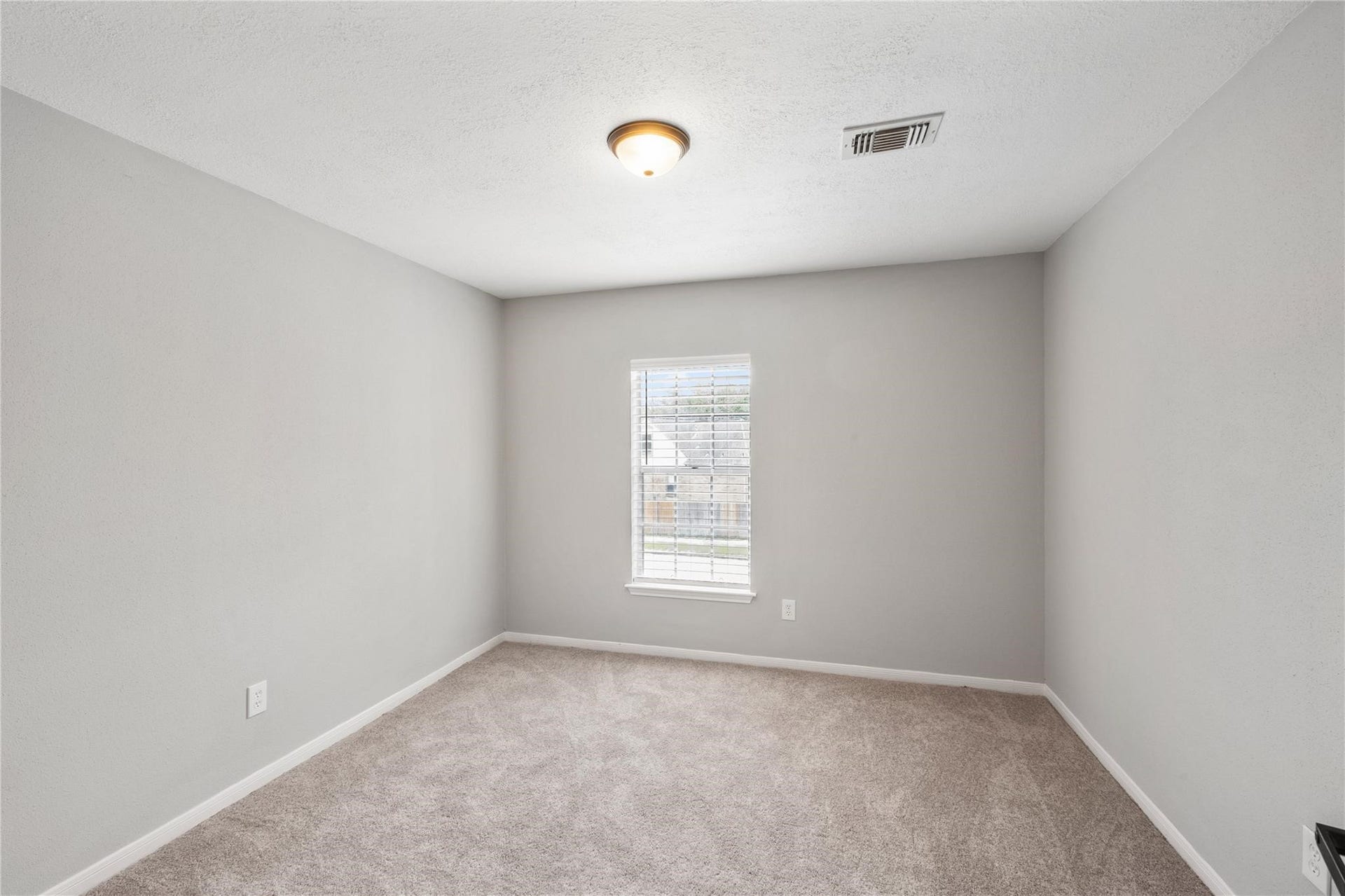 4523 Waterfall Way, Sugar Land, TX 77479 The third bedroom offers comfortable accommodations with soft carpeting, natural light, and a neutral color palette.