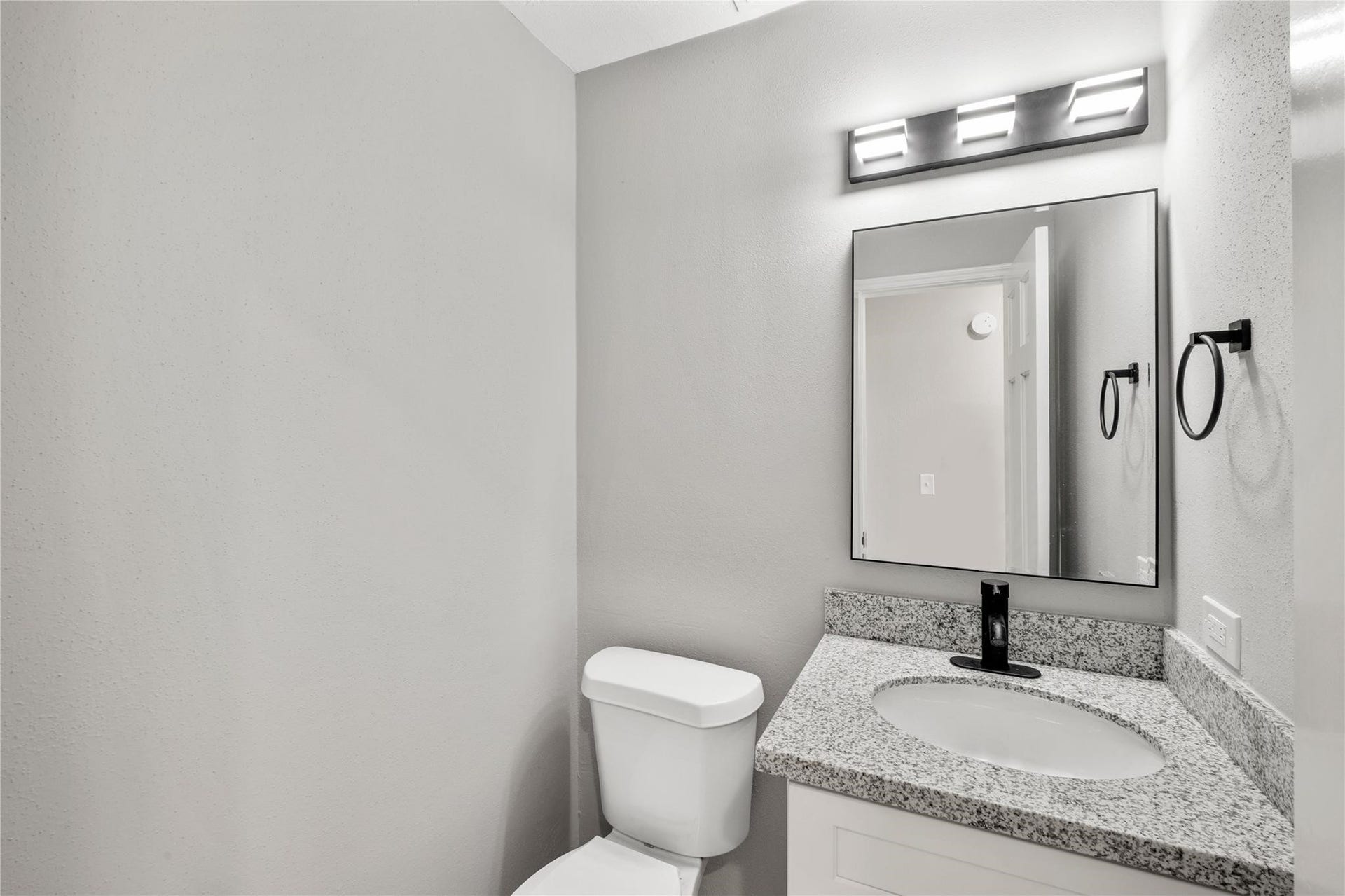 4523 Waterfall Way, Sugar Land, TX 77479 The updated half bath features a granite vanity, modern fixtures, and stylish finishes that complement the home's recent renovations.