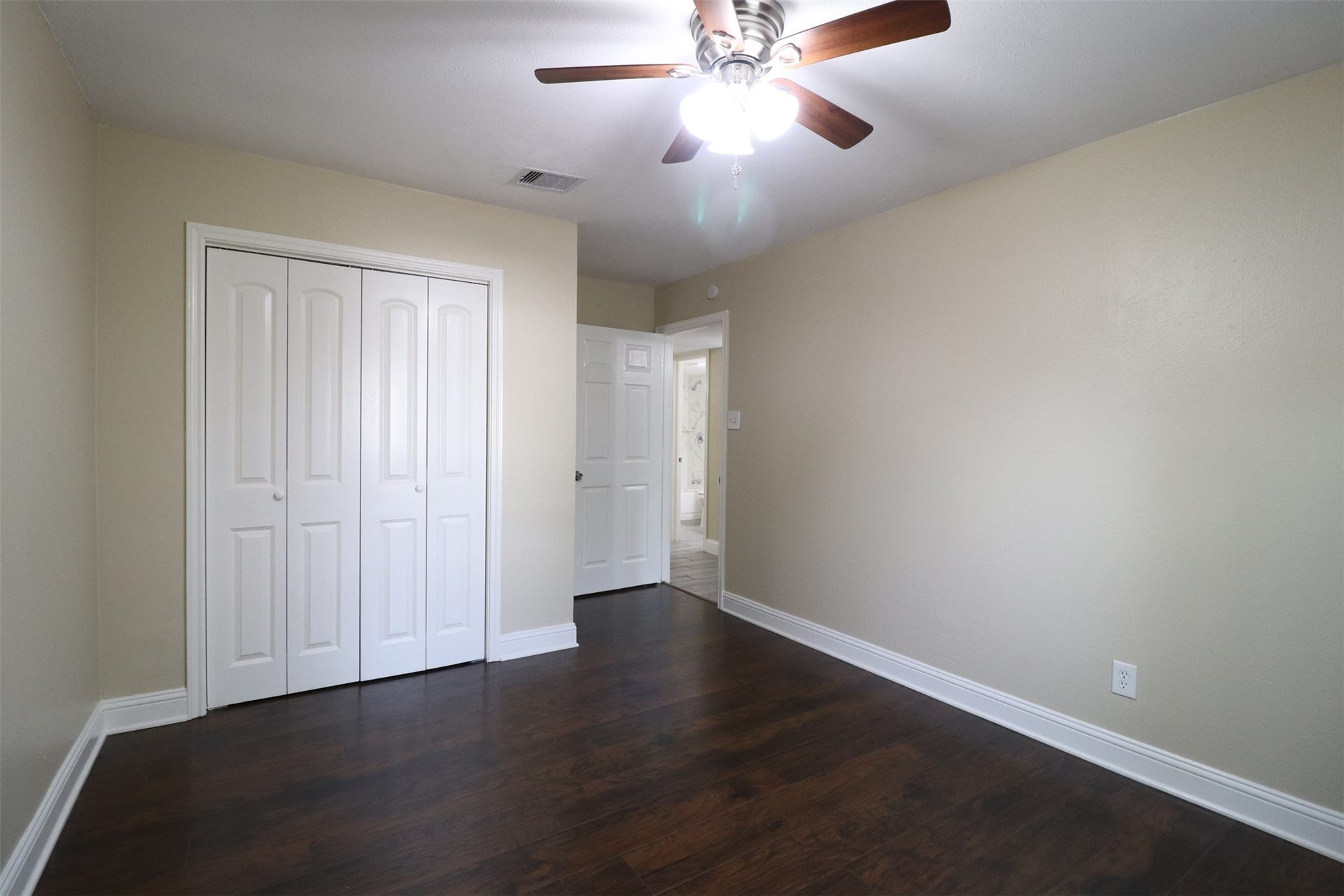 2nd bedroom with closet and hallway to the right.