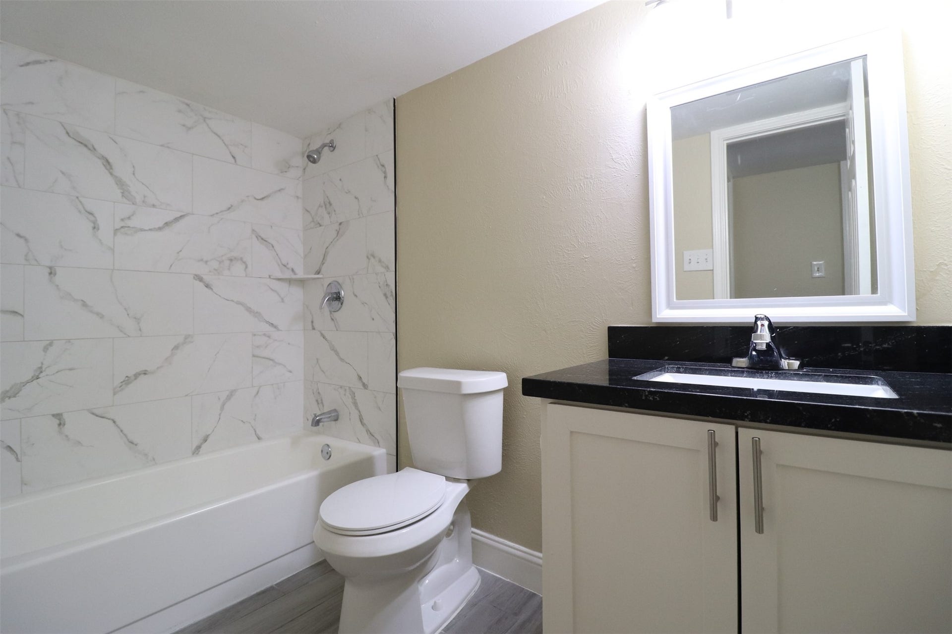Secondary bathroom with shower/tub combo right off the hallway.