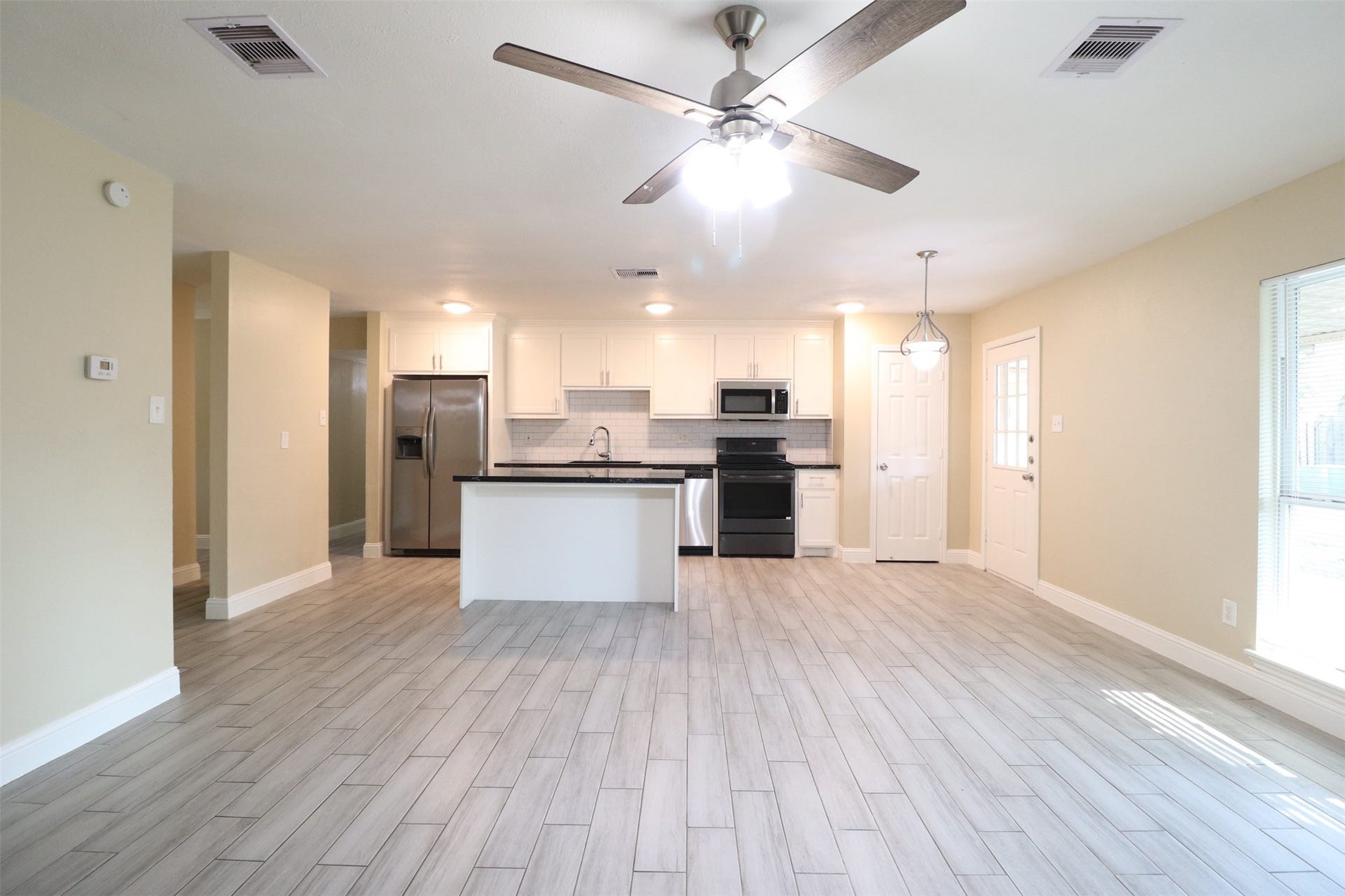 Another view of living room open to the kitchen. Pantry on the right.
