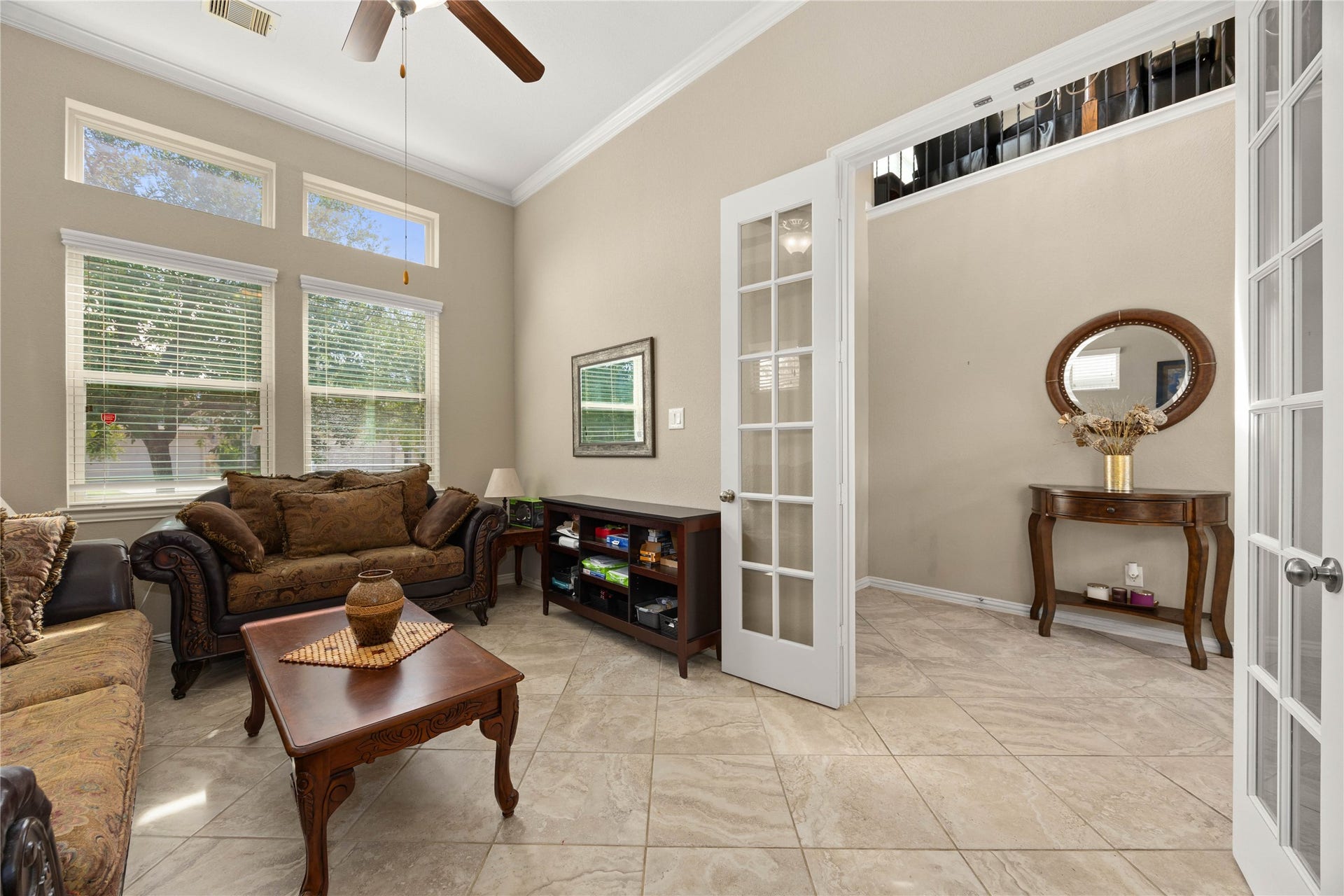 18707 Fox Kestrel Trail, Cypress, TX 77429 Bright and inviting living room with high ceilings, elegant French doors, and large windows offering plenty of natural light.