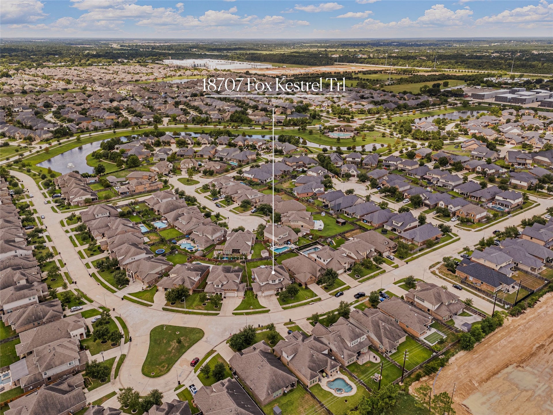 18707 Fox Kestrel Trail, Cypress, TX 77429 Aerial view of a spacious suburban neighborhood featuring well-kept homes, curving streets, and lush greenery, offering a serene community setting.
