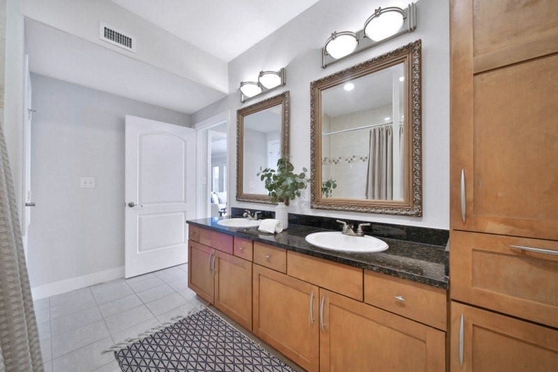2299 Lone Star Drive, #406, Sugar Land, TX 77479 The view of hallway full bath W/Double sinks and granite counter-tops.