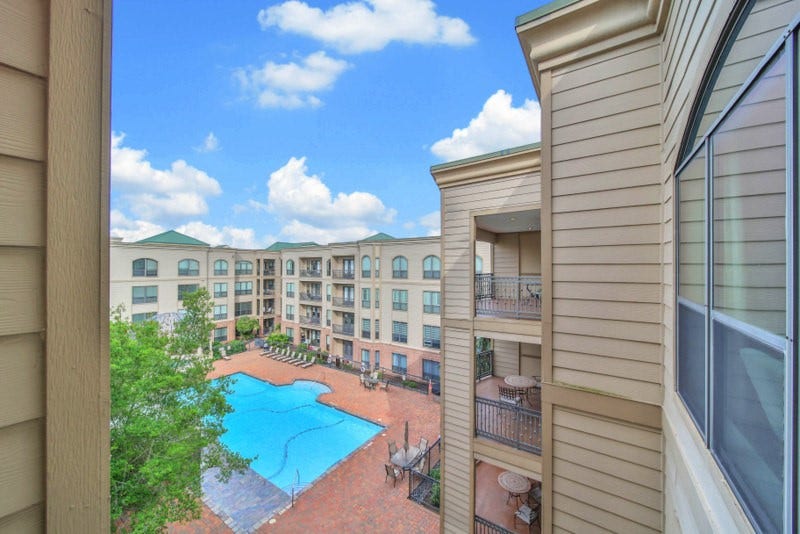 2299 Lone Star Drive, #406, Sugar Land, TX 77479 The courtyard and sparling pool views form balony.