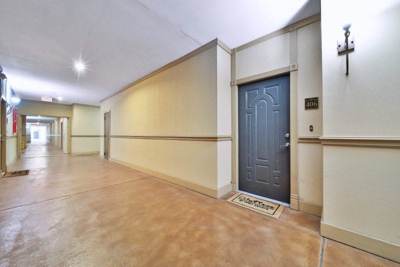 2299 Lone Star Drive, #406, Sugar Land, TX 77479 The view of hallway of unit 406--A FEW Steps away from parking garage\.