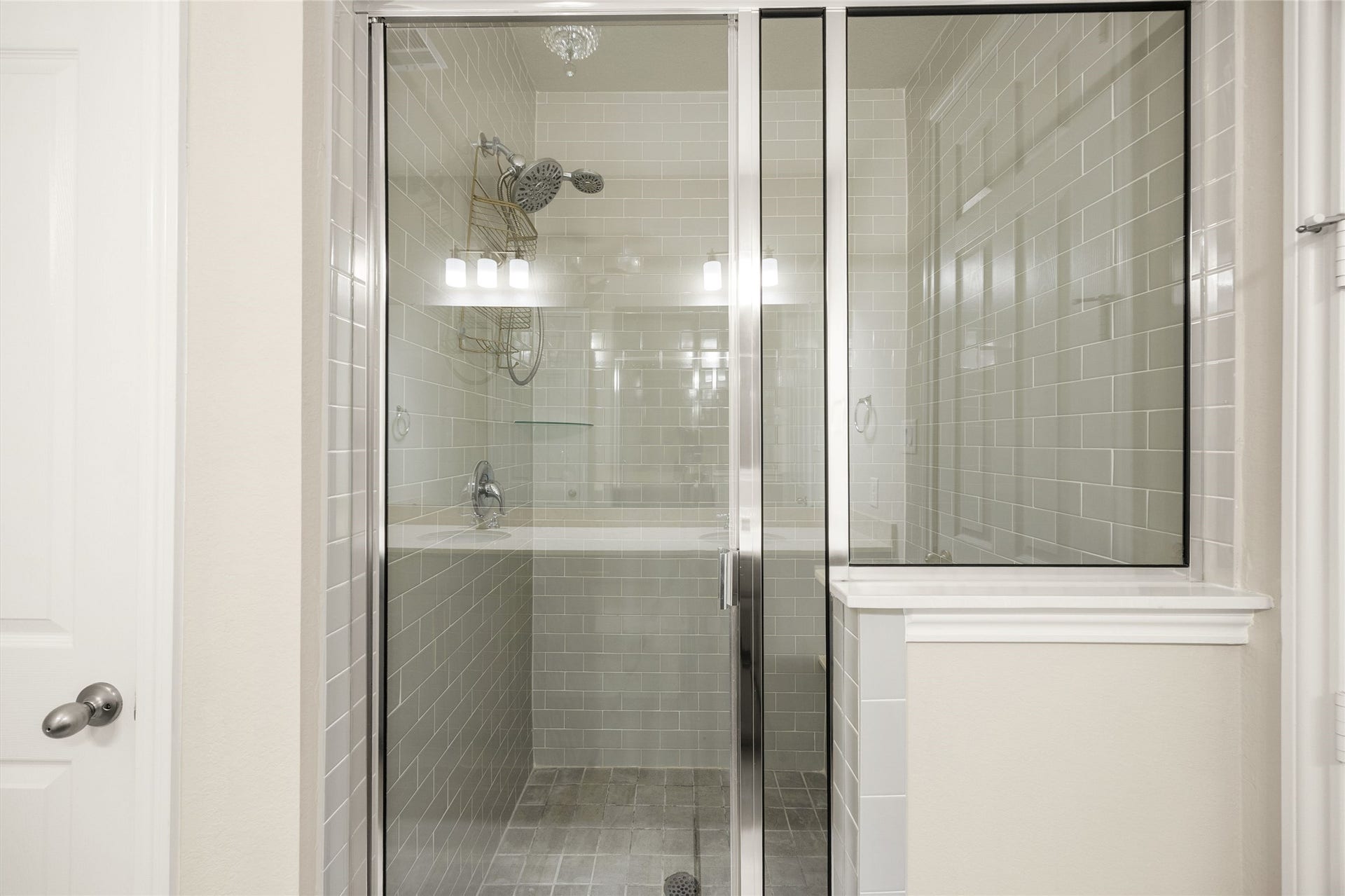 18223 Crystal Knoll Drive, Cypress, TX 77433 Glass shower doors keep the look open while showing off the full tile surround and generous shower area.