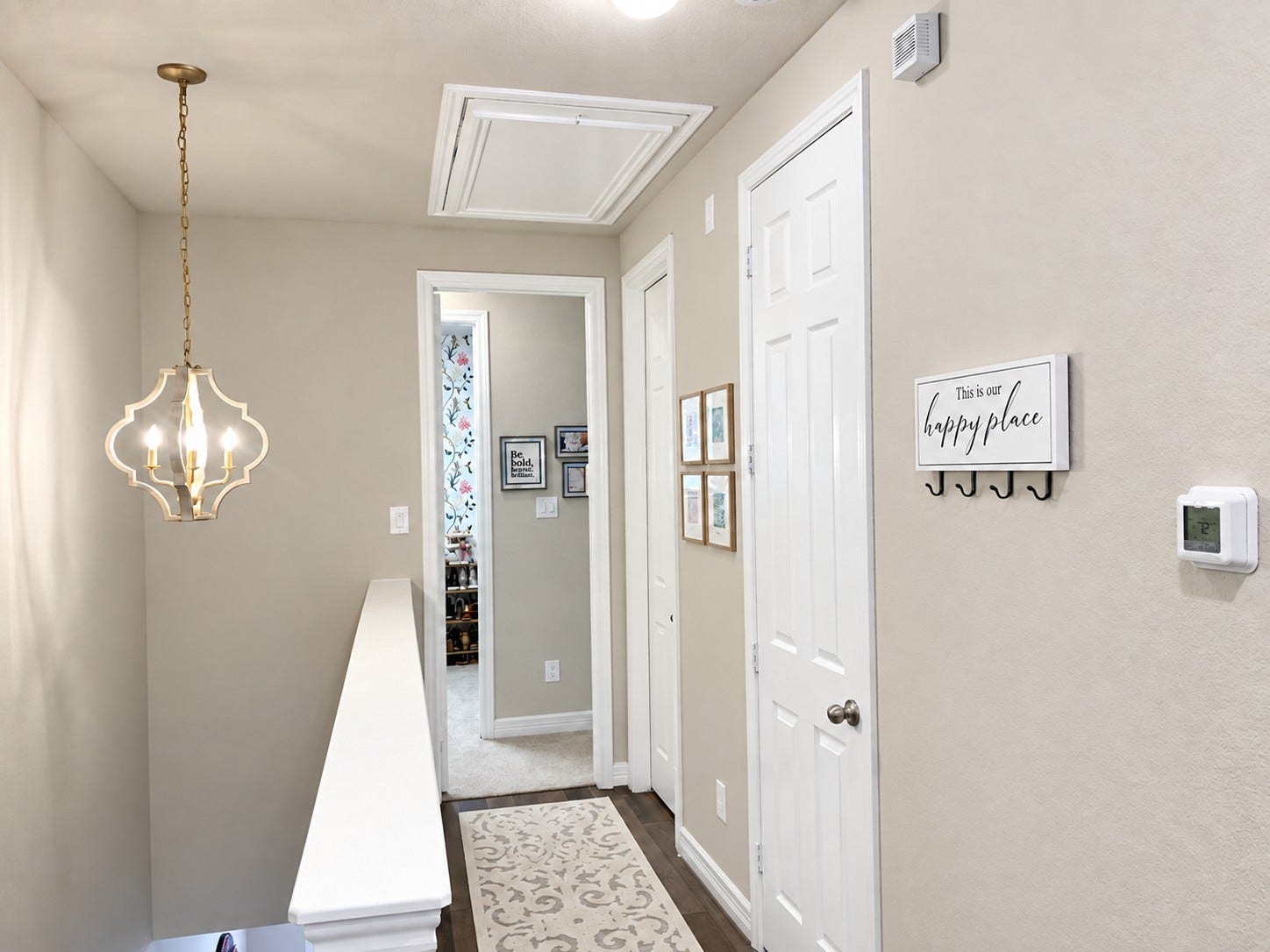 18223 Crystal Knoll Drive, Cypress, TX 77433 The beautiful chandelier lights the hallway leading to the half bathroom and large primary suite.