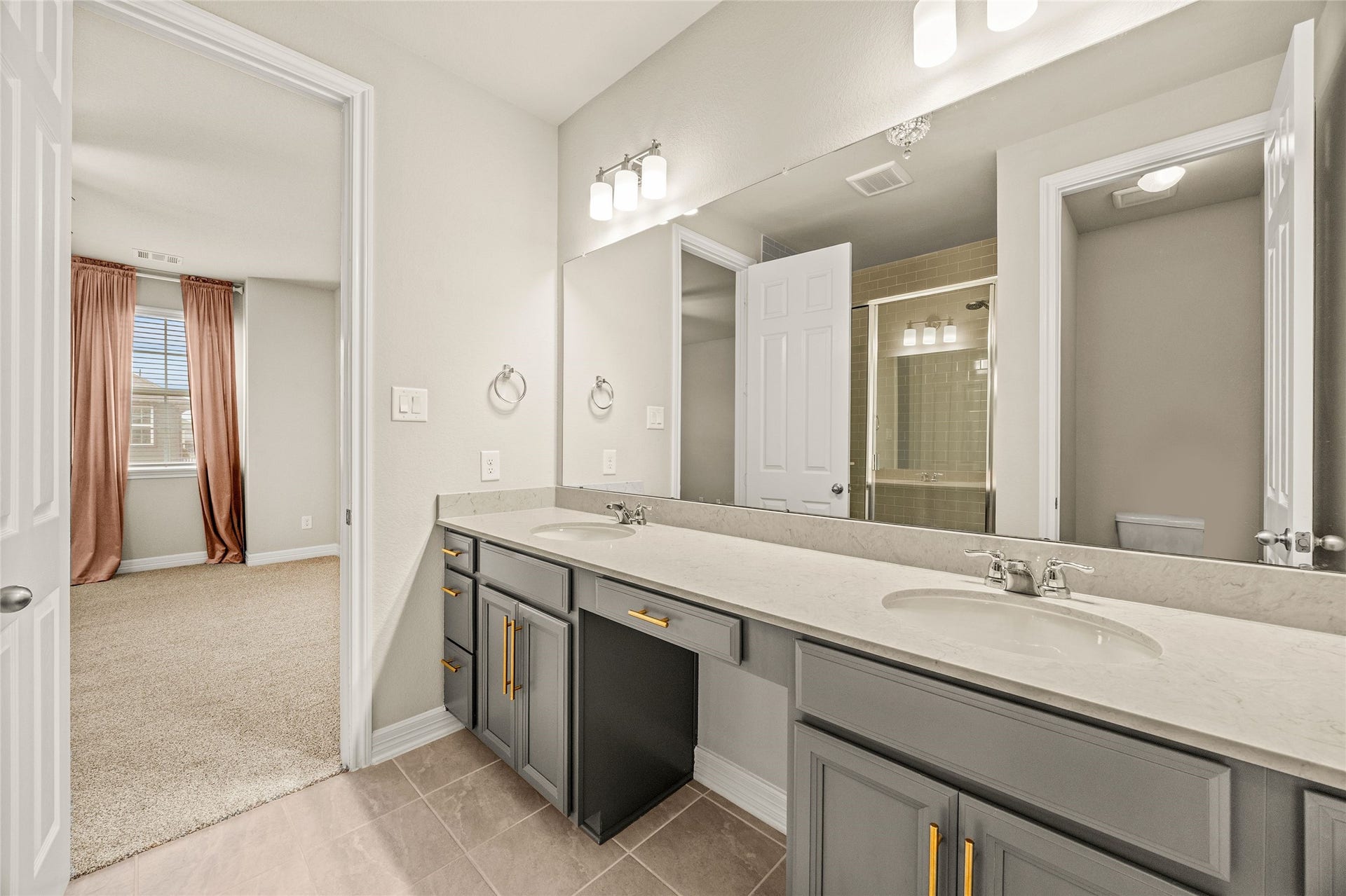 18223 Crystal Knoll Drive, Cypress, TX 77433 A wall-to-wall mirror stretches above the vanity, making the room feel even larger and brighter.