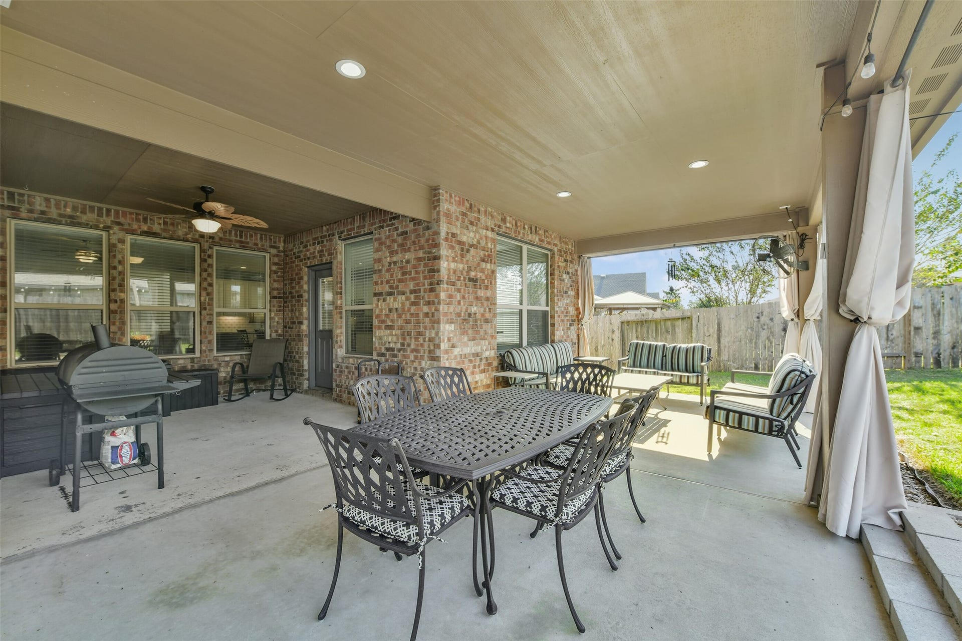 18015 Svensson Slade Lane, Houston, TX 77044 Oversized covered patio 39'x12'+ with recess lighting, countertops & kitchen area & privacy shade curtains