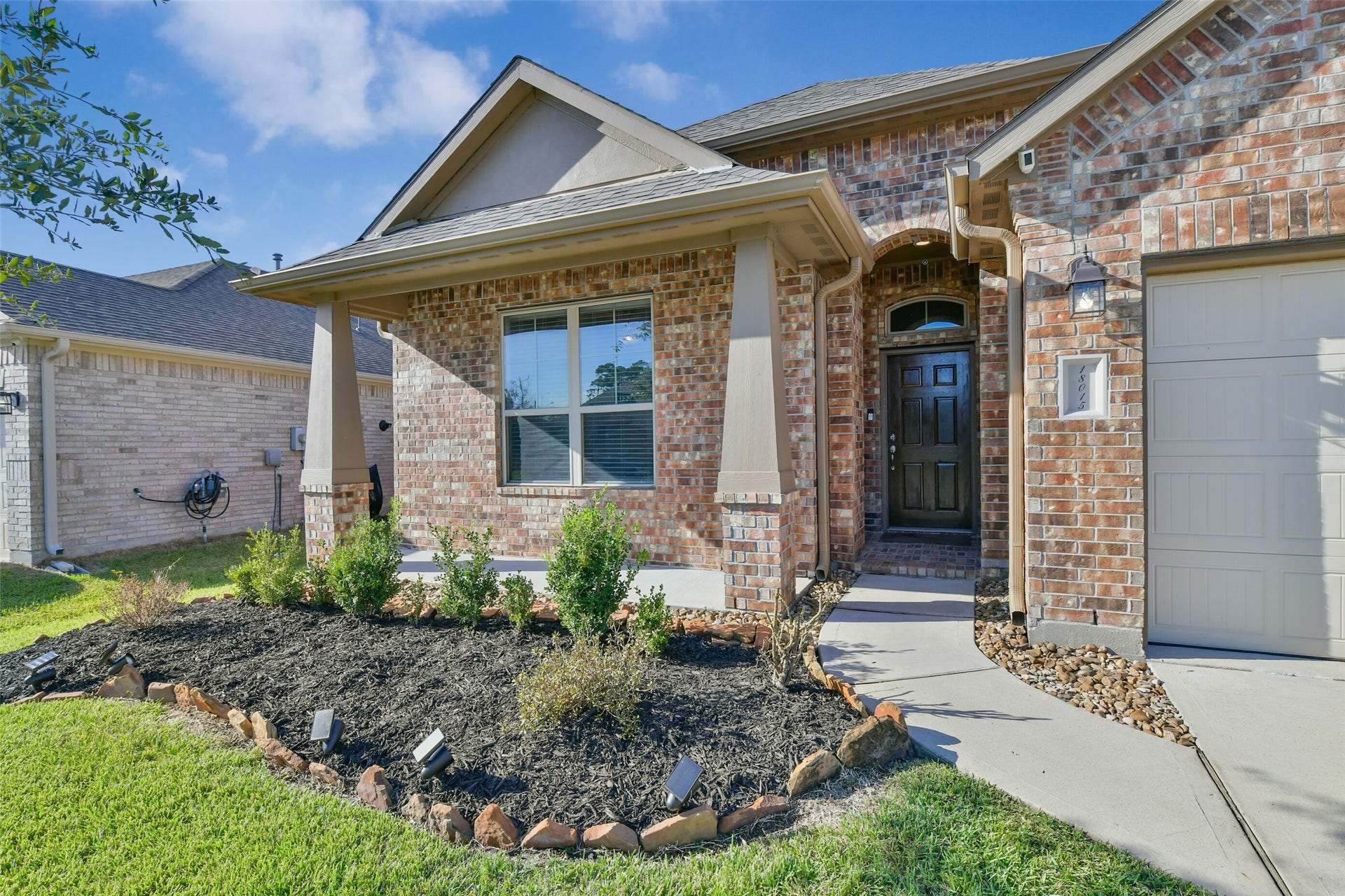 18015 Svensson Slade Lane, Houston, TX 77044 Covered front porch. Fresh mulch. Low maintenance front yard