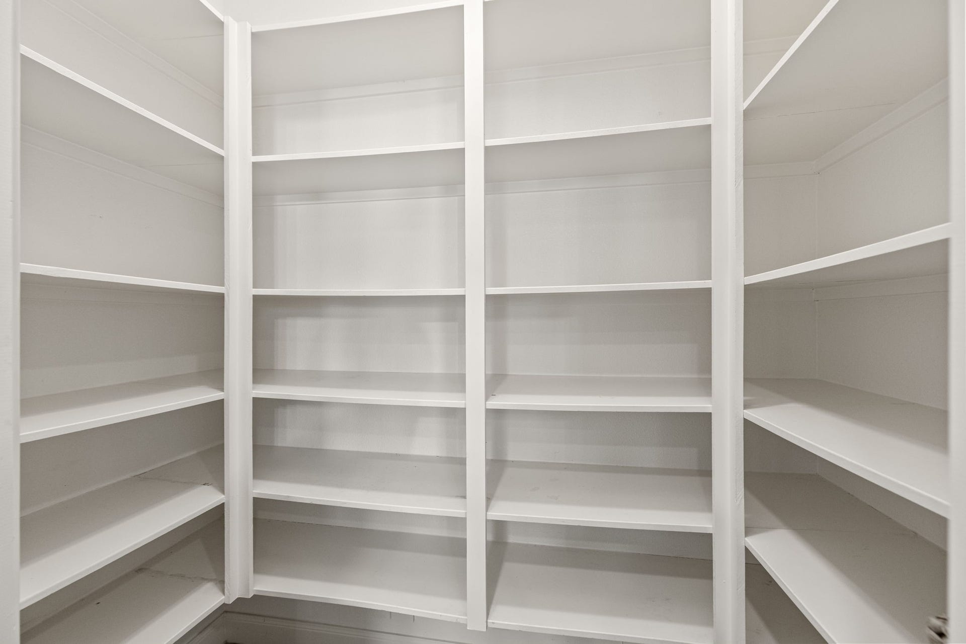 Spacious walk-in pantry with ample shelving for all your storage needs.