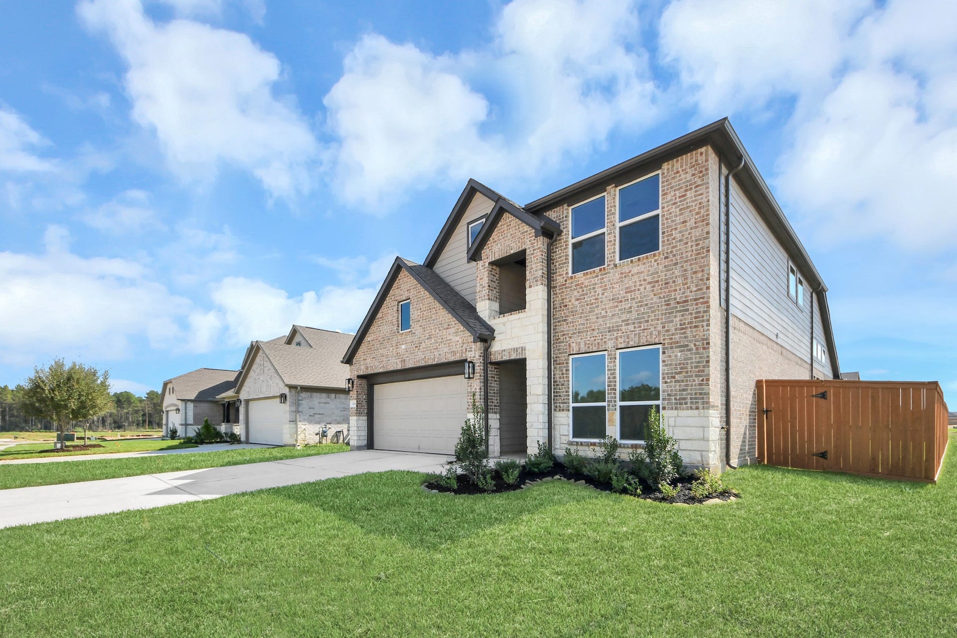 3064 Spoolwood Trail, Magnolia, TX 77355 The residence features a practical 2-car garage complemented by a generous driveway, ensuring abundant space for parking needs.