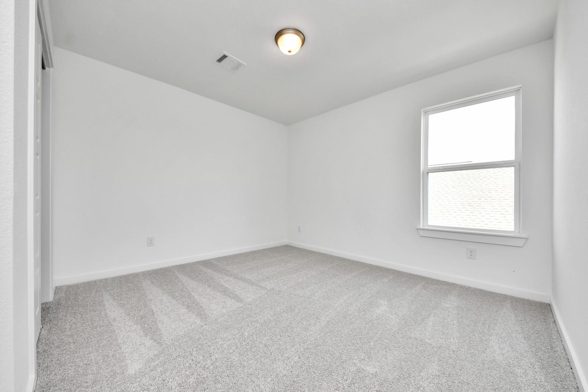 3064 Spoolwood Trail, Magnolia, TX 77355 Secondary bedroom features plush carpeting, large windows that let in plenty of natural light, bright paint, and spacious closets.
