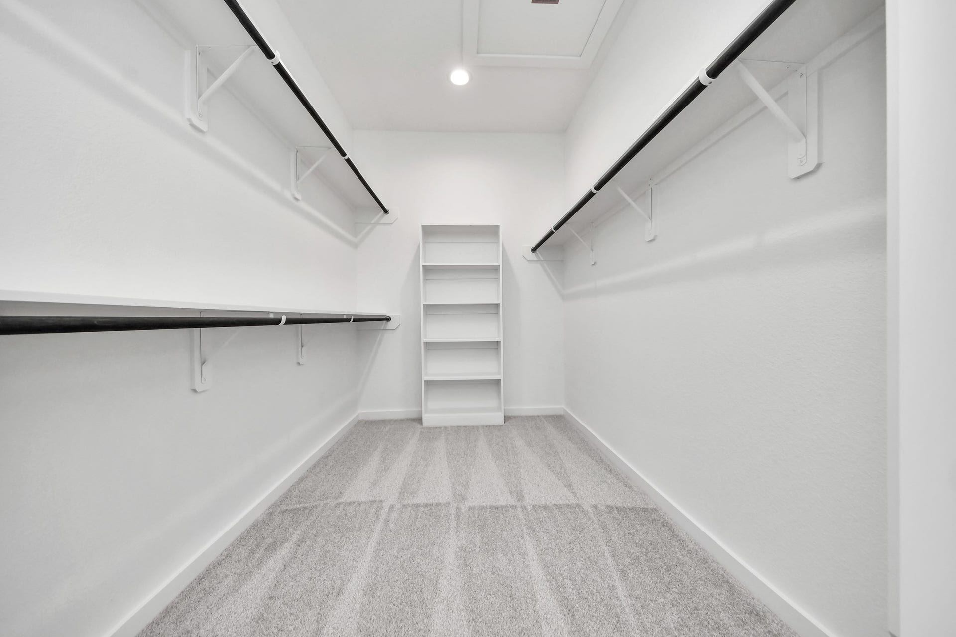 3064 Spoolwood Trail, Magnolia, TX 77355 Walk-in closet that epitomizes luxury and practicality. This generously sized space features built-in shelving, offering abundant room for impeccable organization. High ceilings and recessed lighting create a bright and welcoming ambiance.