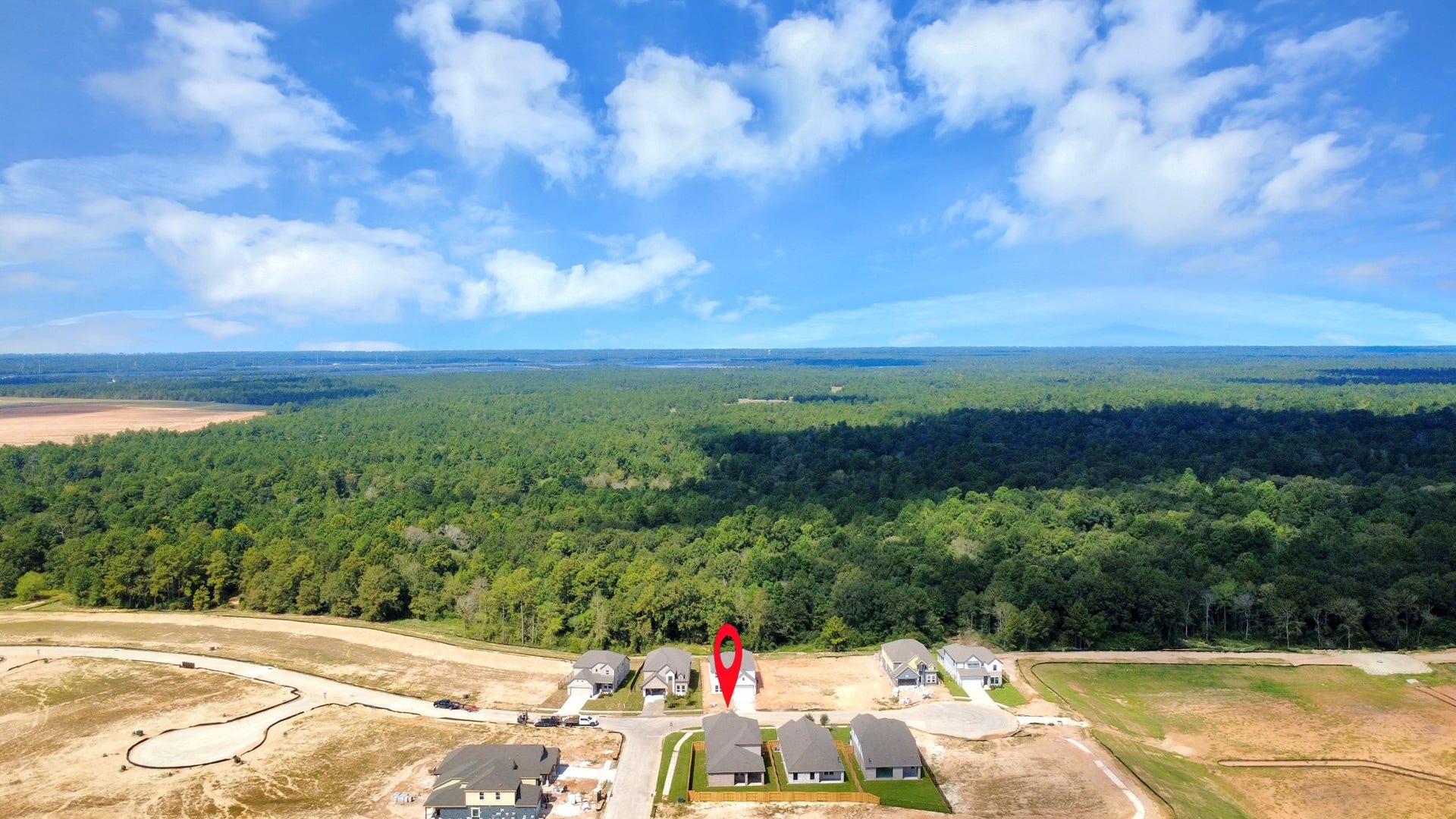 3064 Spoolwood Trail, Magnolia, TX 77355 An aerial view of a spacious subdivision lot, highlighting a well-maintained yard and a fully fenced perimeter, offering both privacy and expansive outdoor space.