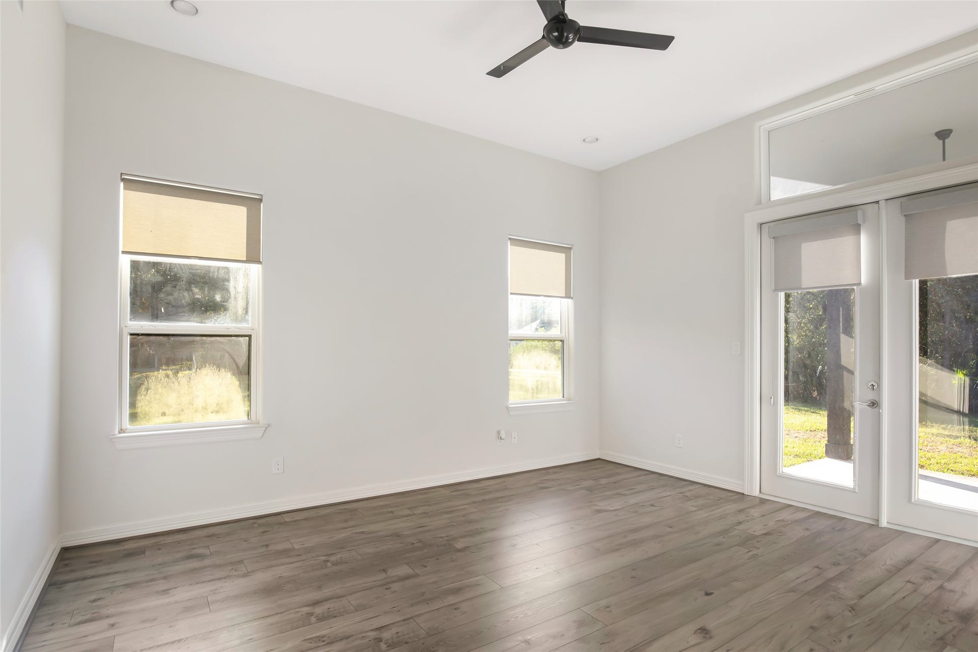 538 Magnolia Point Drive, Huffman, TX 77336 Master bedroom with high ceilings, recessed lighting, new flooring, and transom-topped French doors