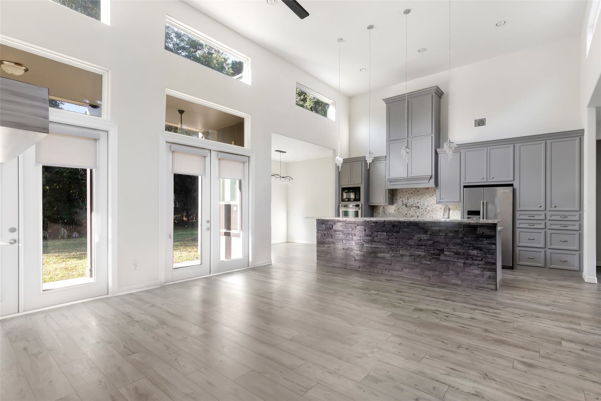 538 Magnolia Point Drive, Huffman, TX 77336 Transom-topped French doors and high ceilings accented with clerestory windows