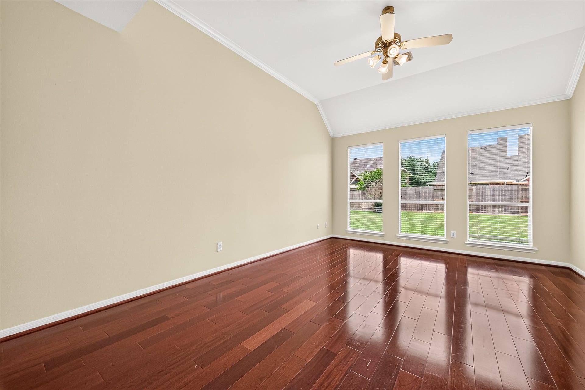 1711 Emma Cove Court, Sugar Land, TX 77479 Primary bedroom is filled with natural light from three tall windows overlooking the backyard.