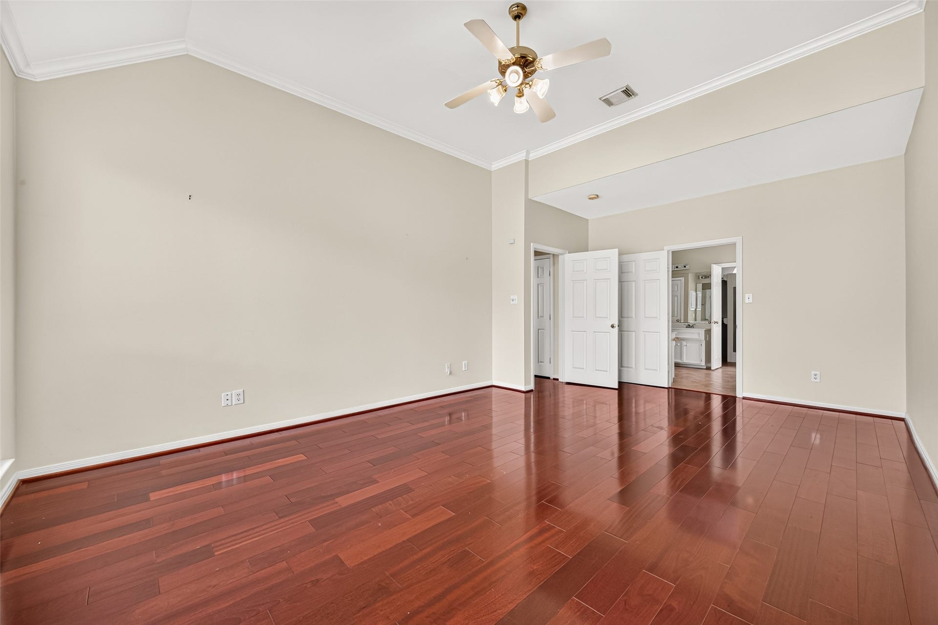 1711 Emma Cove Court, Sugar Land, TX 77479 Rich wood flooring, crown molding, and a tray ceiling add warmth and character to the primary retreat.