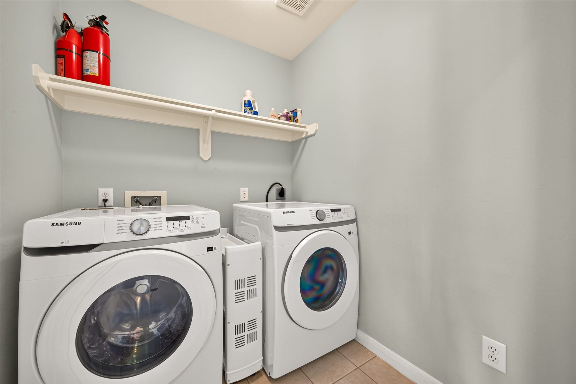 1711 Emma Cove Court, Sugar Land, TX 77479 Separate utility room offers built-in shelving and space for full-size front-loading laundry appliances.