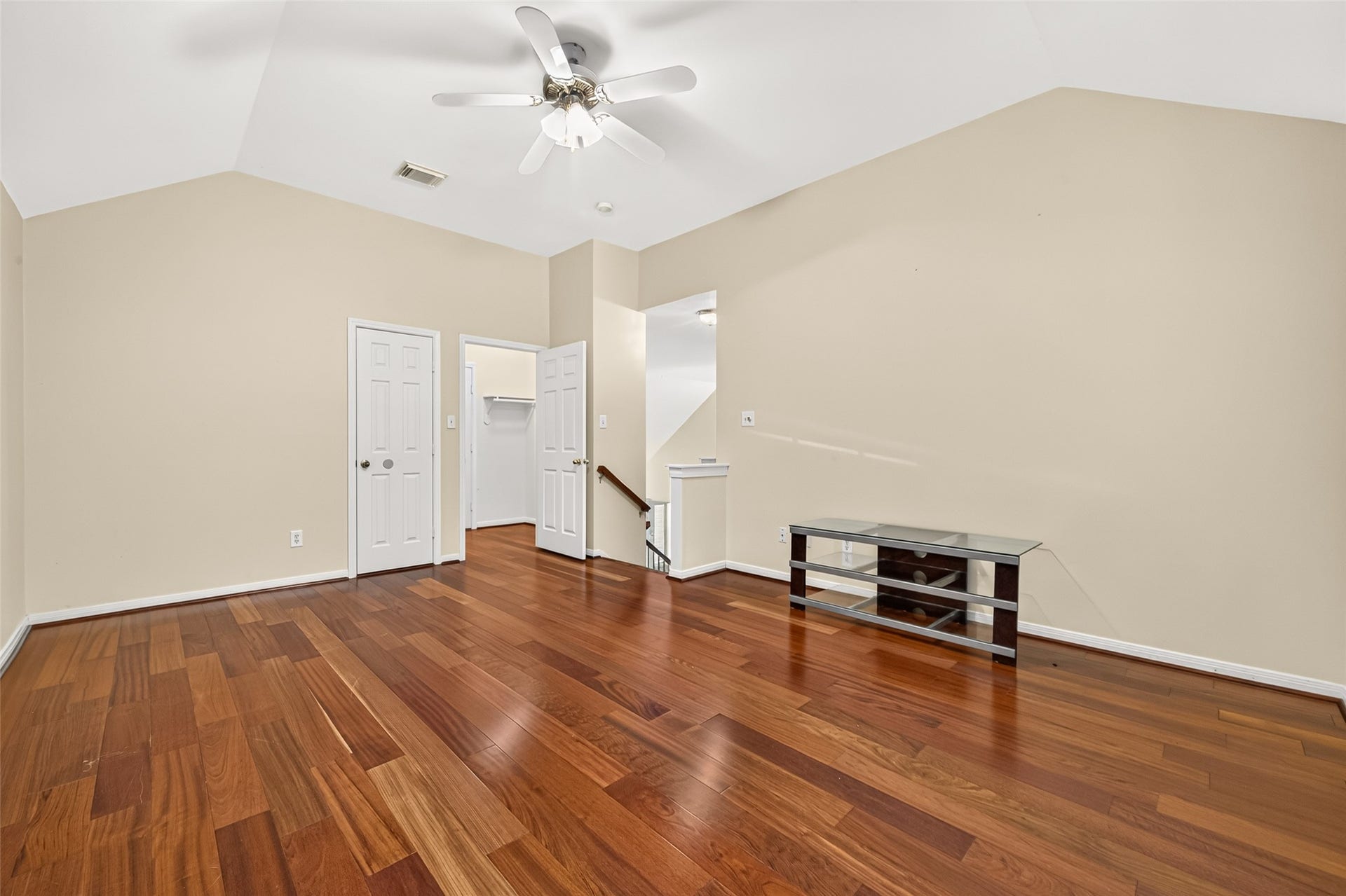 1711 Emma Cove Court, Sugar Land, TX 77479 Flexible upstairs game room includes hardwood flooring, a ceiling fan, and access to multiple storage areas.