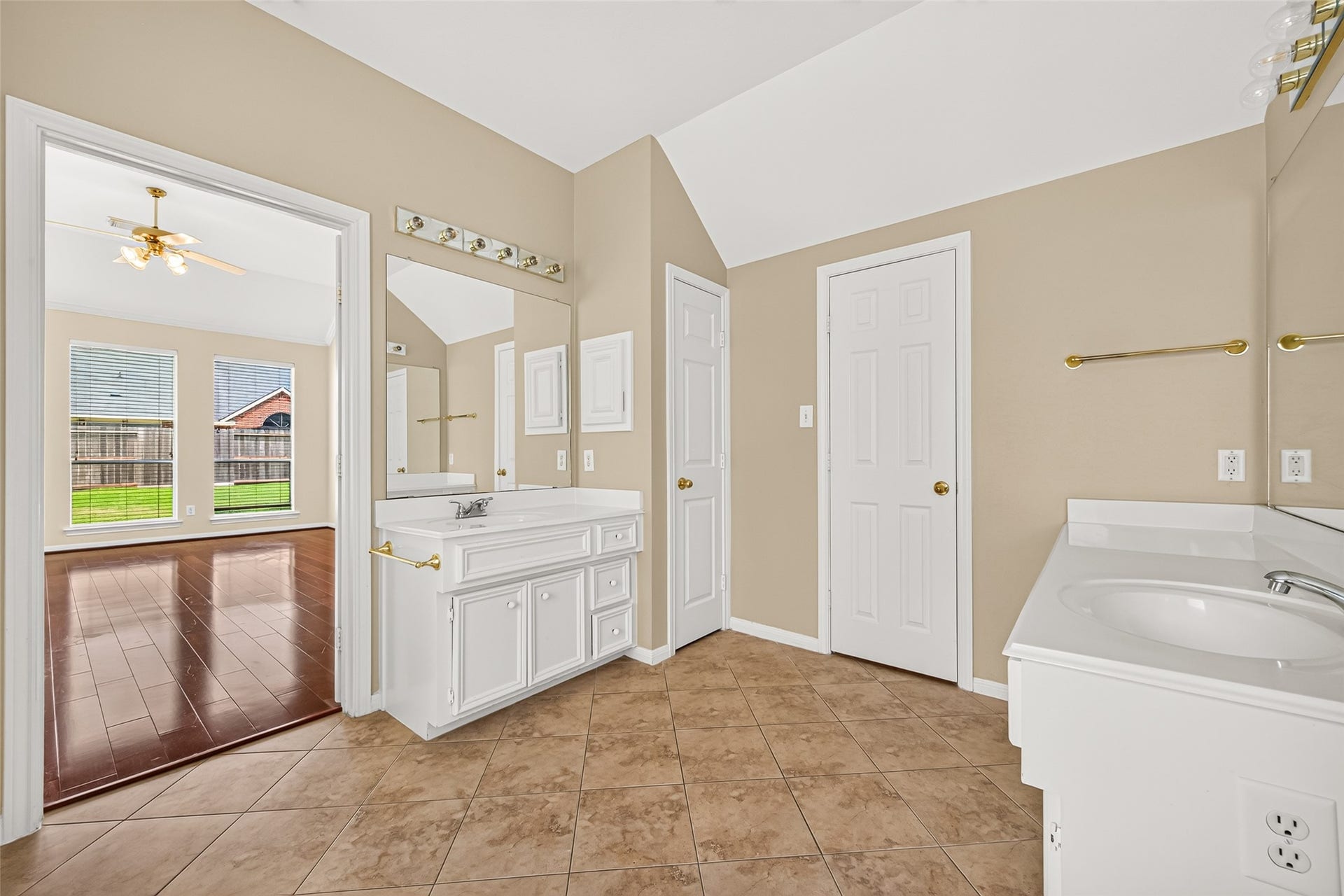 1711 Emma Cove Court, Sugar Land, TX 77479 Separate vanity areas offer added convenience, while neutral finishes create a clean and versatile setting.