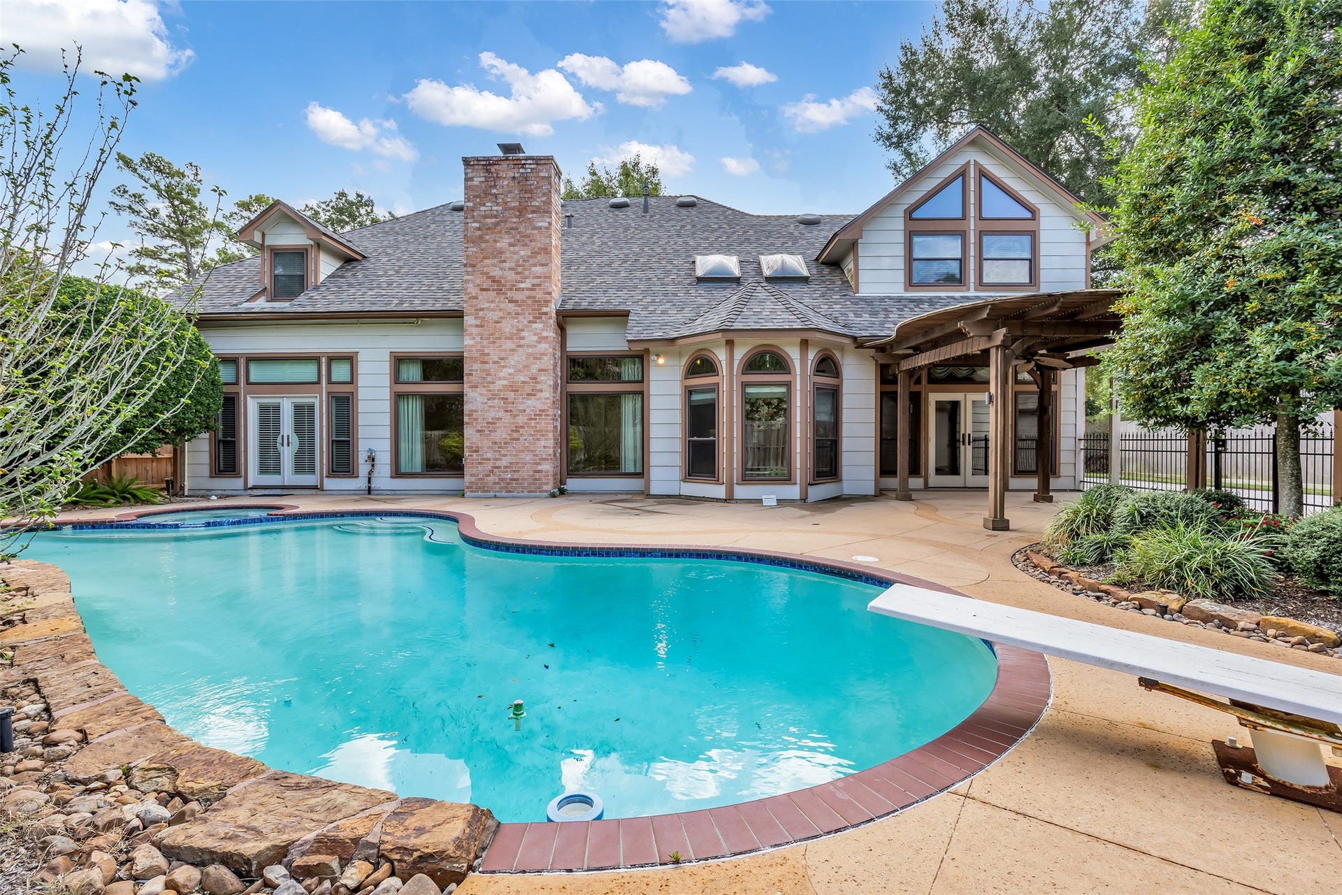 5907 Rocky Brook Drive, Houston, TX 77345 Private pool surrounded by mature landscaping and an expansive patio.
