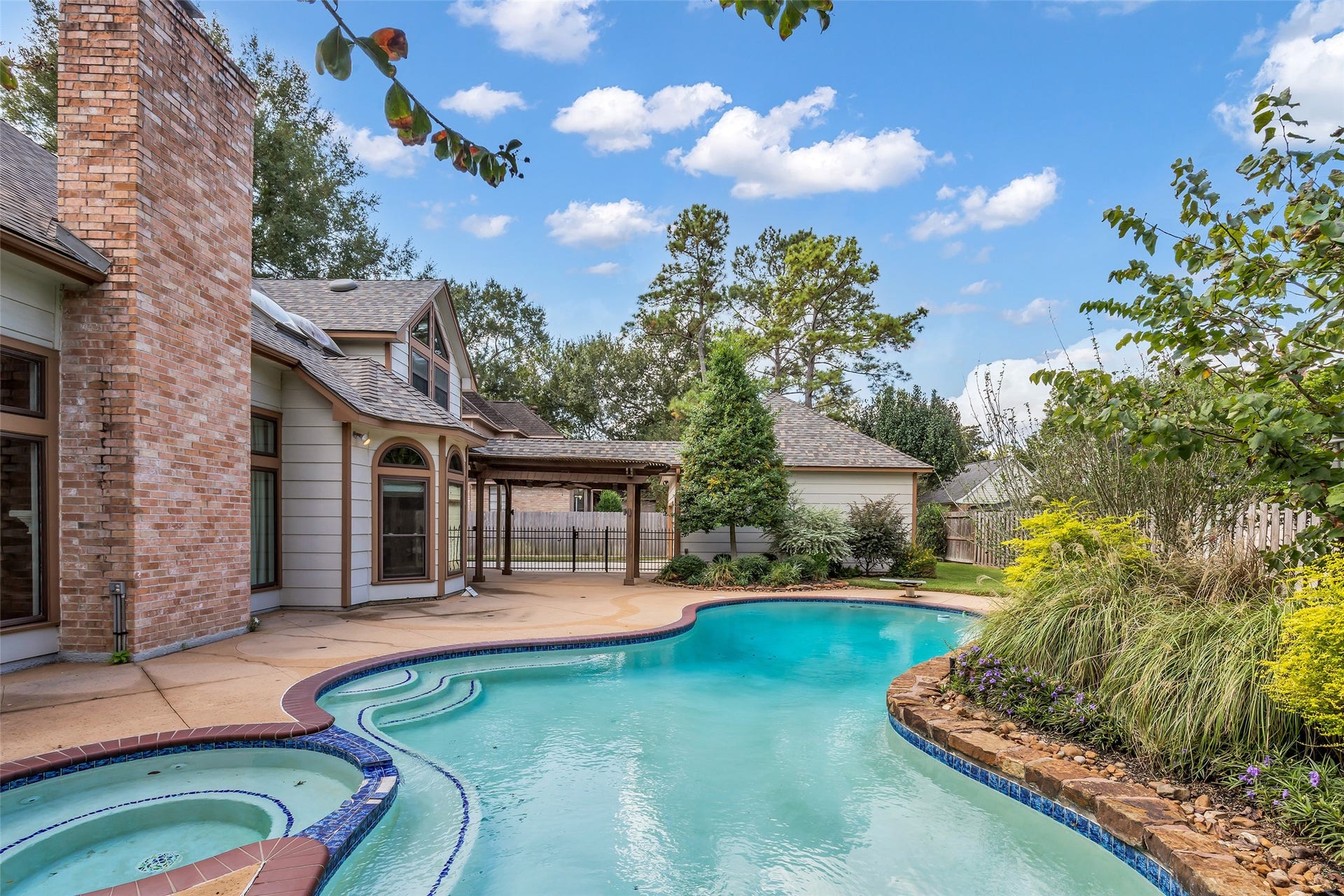 5907 Rocky Brook Drive, Houston, TX 77345 Private pool surrounded by mature landscaping and an expansive patio.