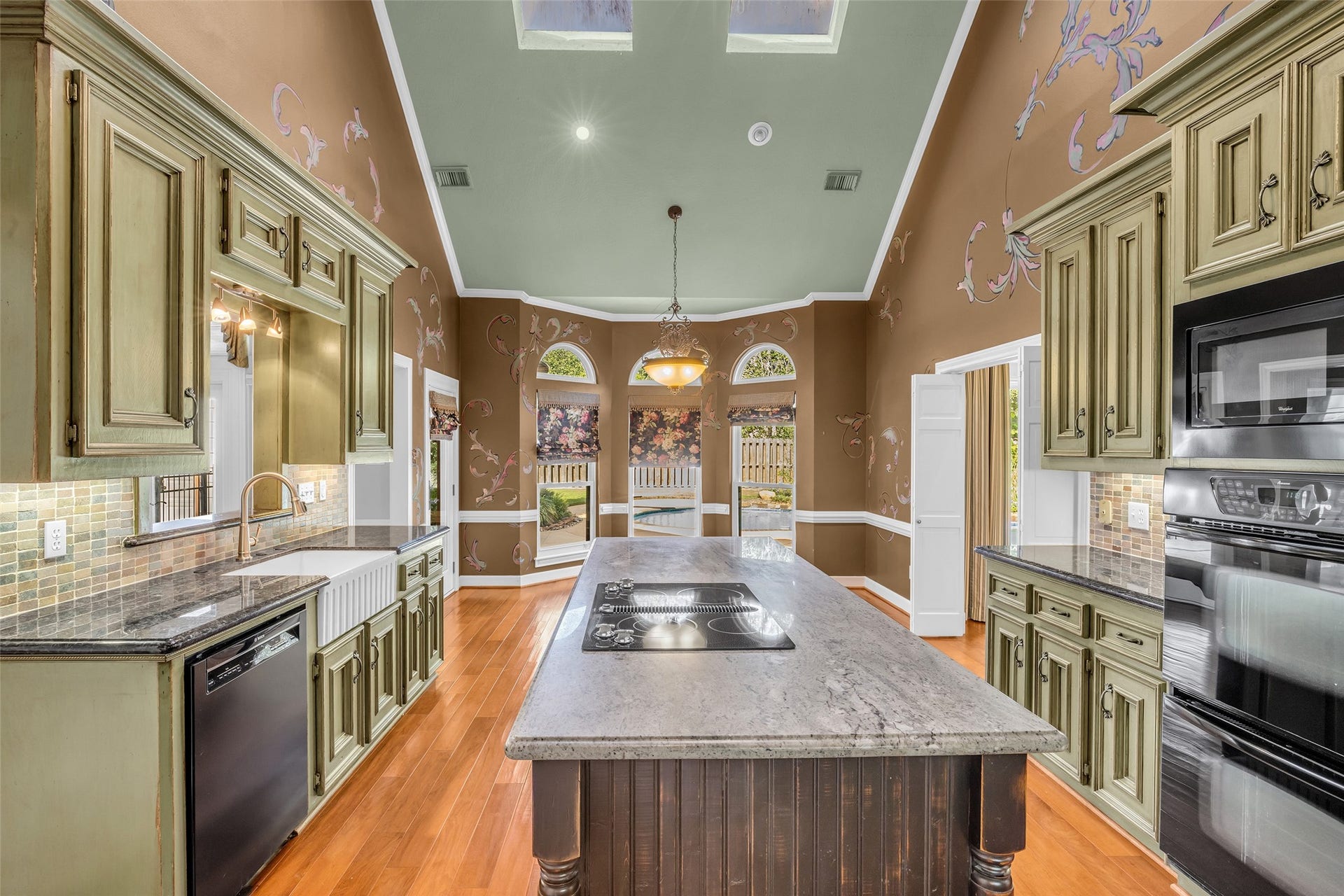 5907 Rocky Brook Drive, Houston, TX 77345 Two-story kitchen with large center island, breakfast area, and skylights.