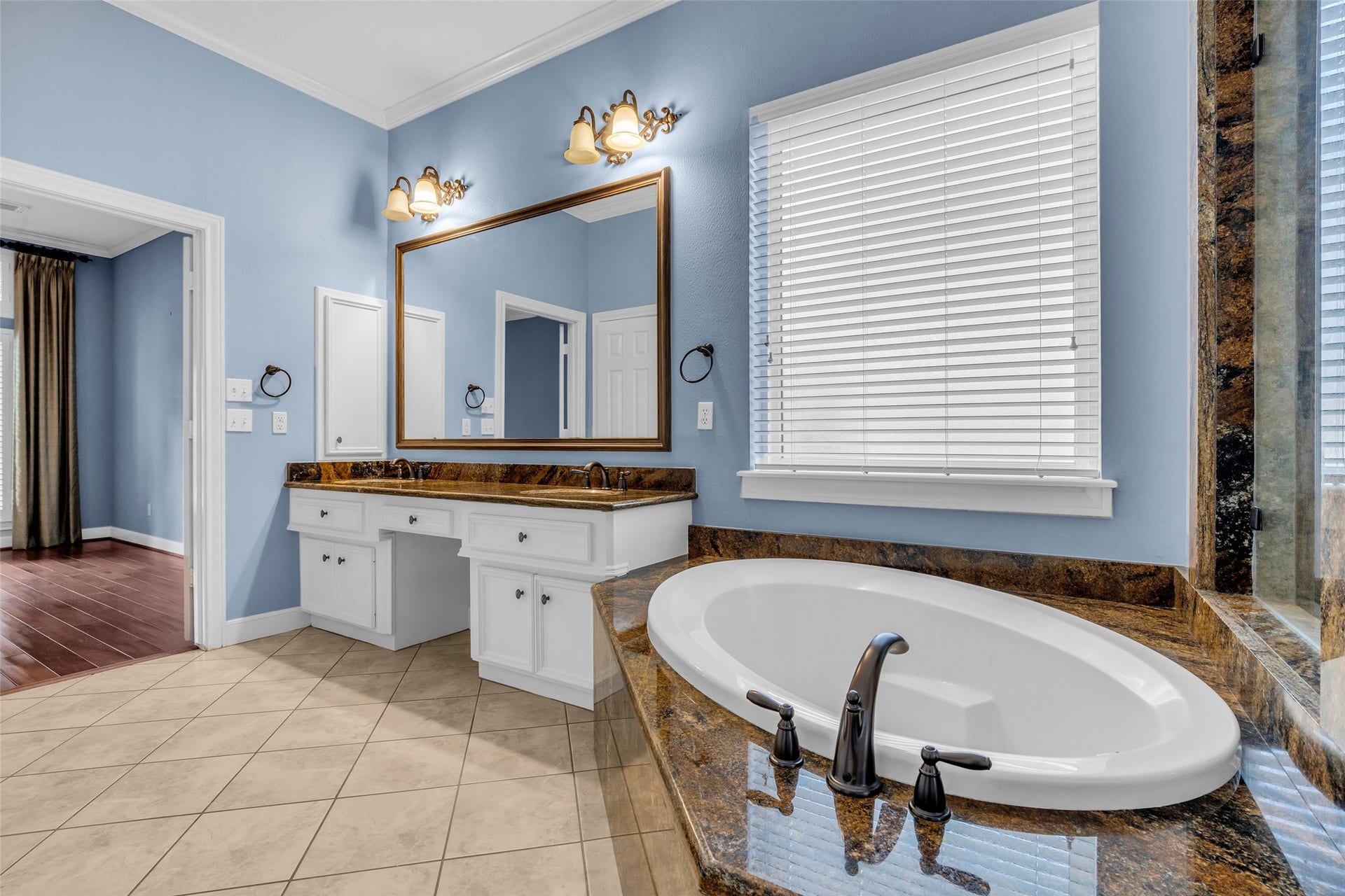 5907 Rocky Brook Drive, Houston, TX 77345 Spacious primary bathroom with granite countertops, soaking tub, separate glass-enclosed shower, two walk-in-closets