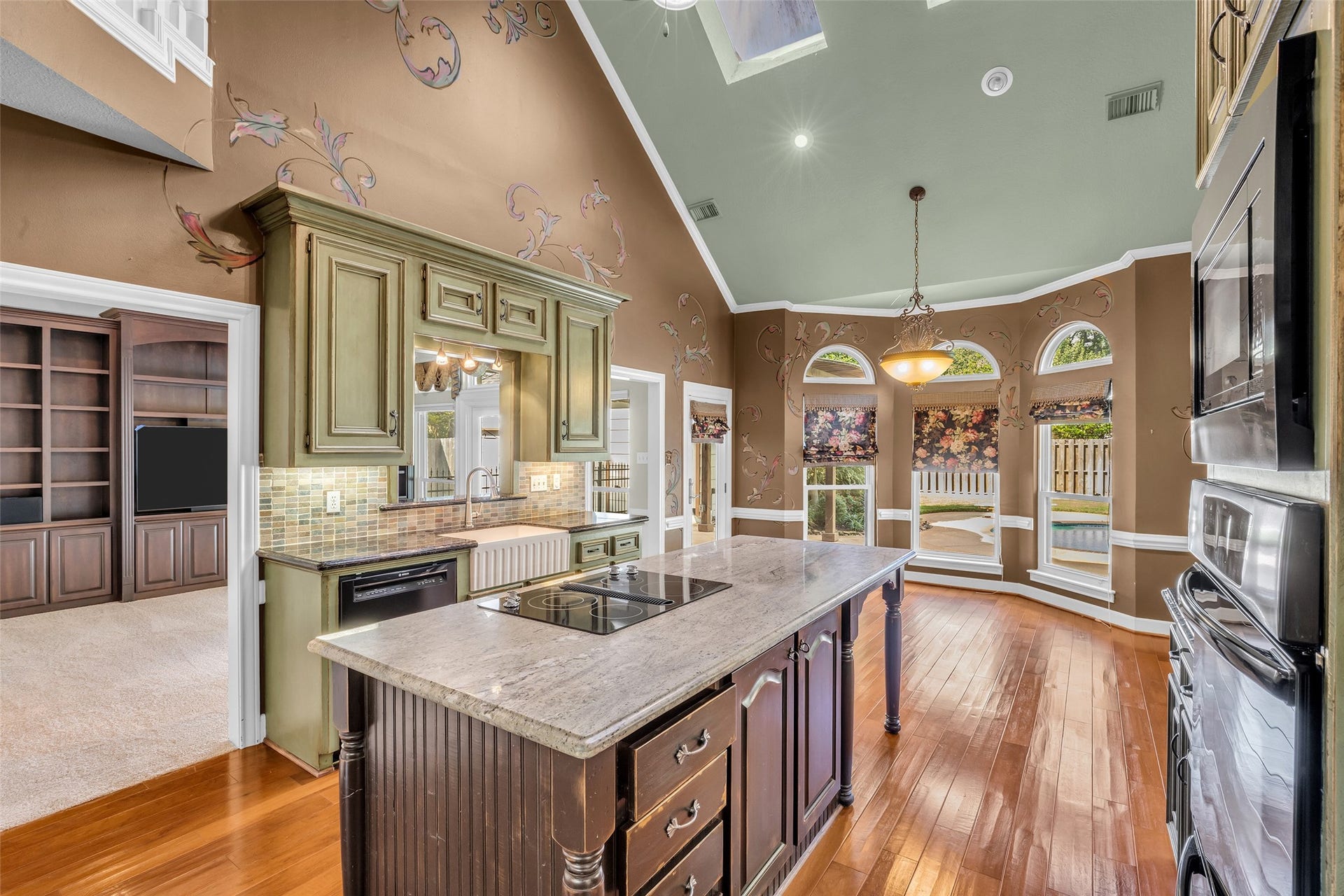 5907 Rocky Brook Drive, Houston, TX 77345 Two-story kitchen with large center island, breakfast area, and skylights.