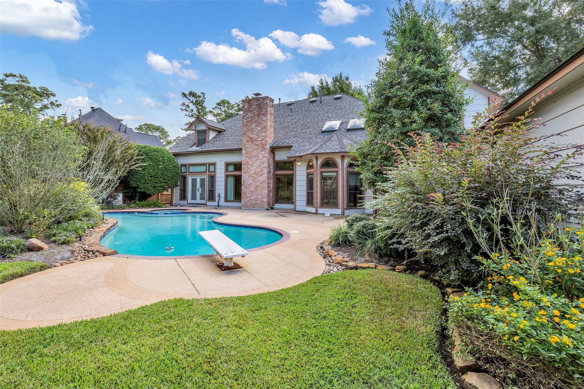 5907 Rocky Brook Drive, Houston, TX 77345 Private pool surrounded by mature landscaping and an expansive patio.