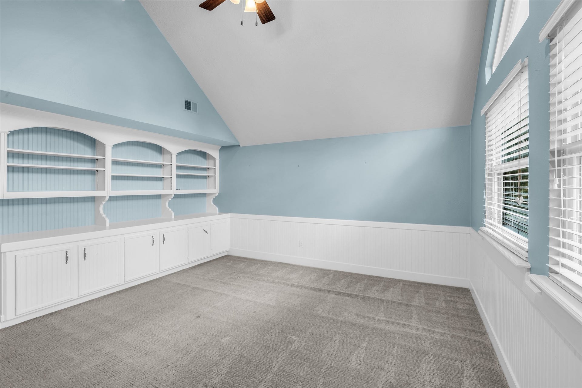5907 Rocky Brook Drive, Houston, TX 77345 Upstairs game room with vaulted ceiling and built-in shelving.