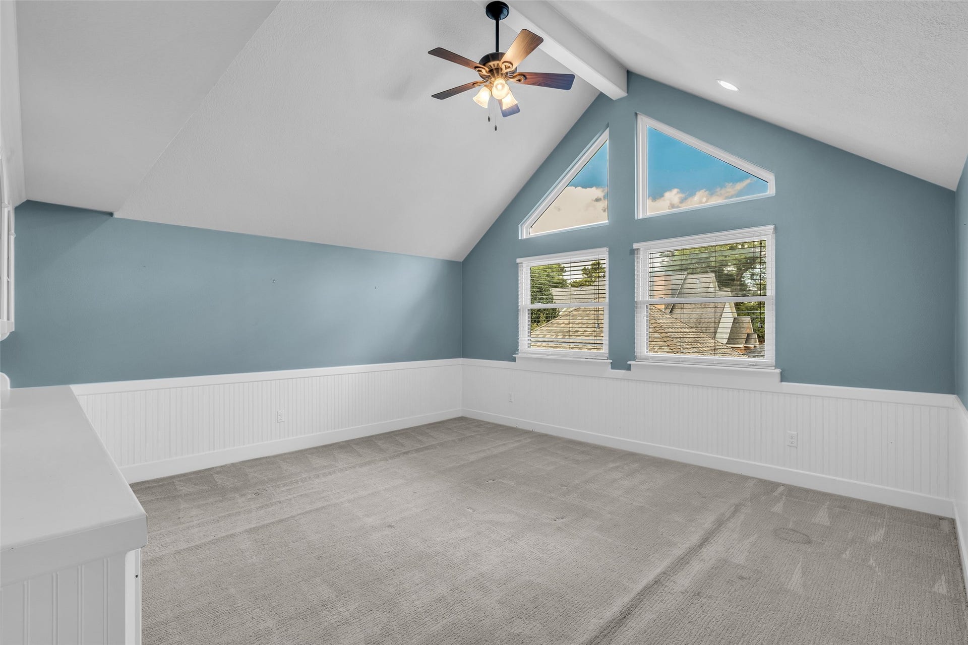 5907 Rocky Brook Drive, Houston, TX 77345 Upstairs game room with vaulted ceiling and built-in shelving.
