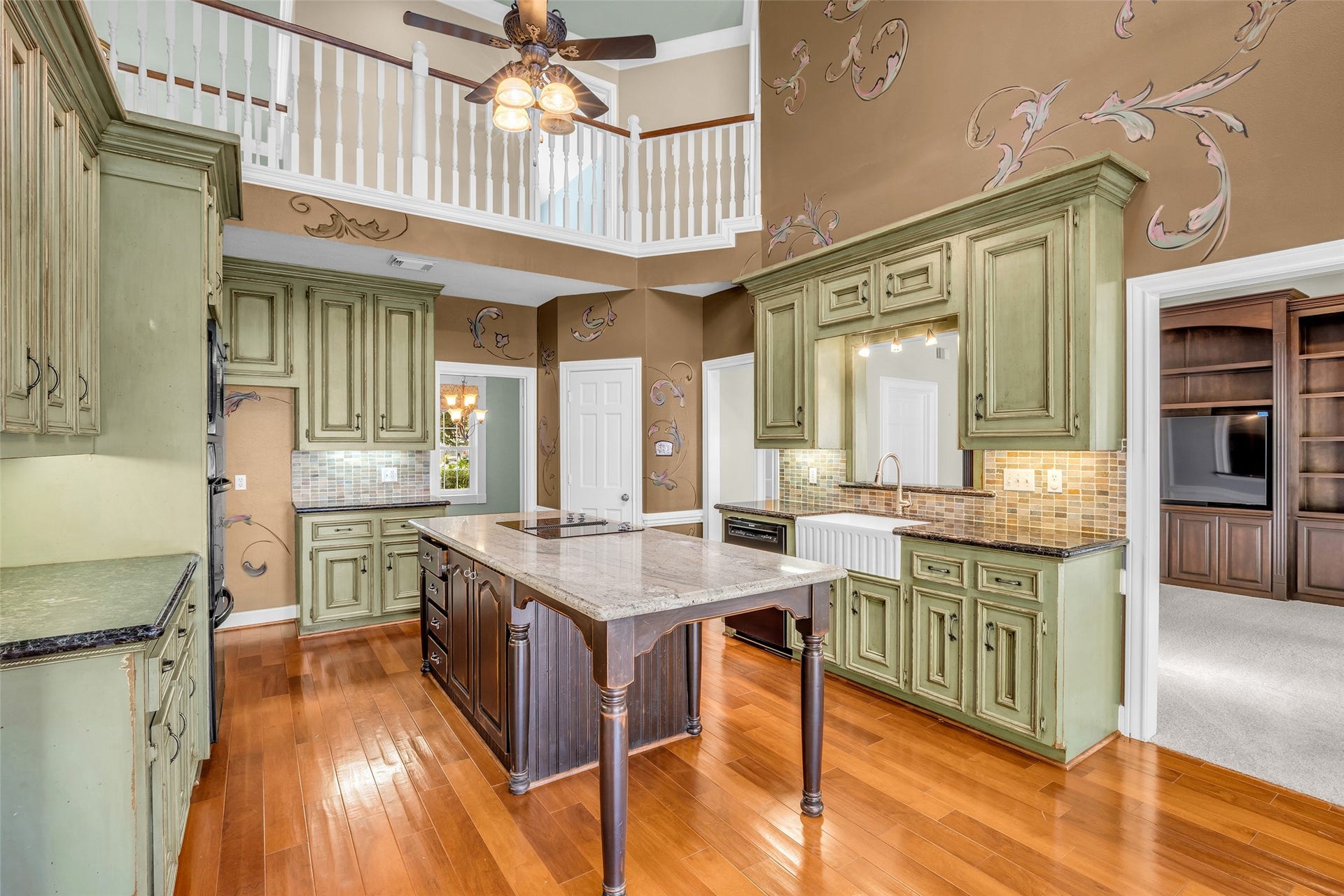 5907 Rocky Brook Drive, Houston, TX 77345 Two-story kitchen with large center island, breakfast area, and skylights.